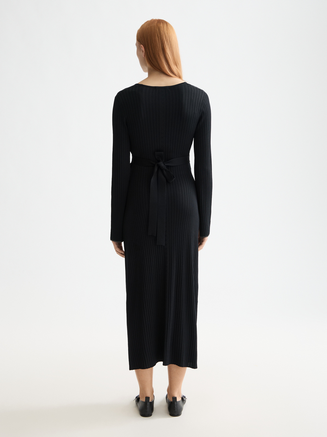 Black ribbed wrap dress from Scotch & Soda, featuring a fitted silhouette and long sleeves, stylish and comfortable for any occasion.