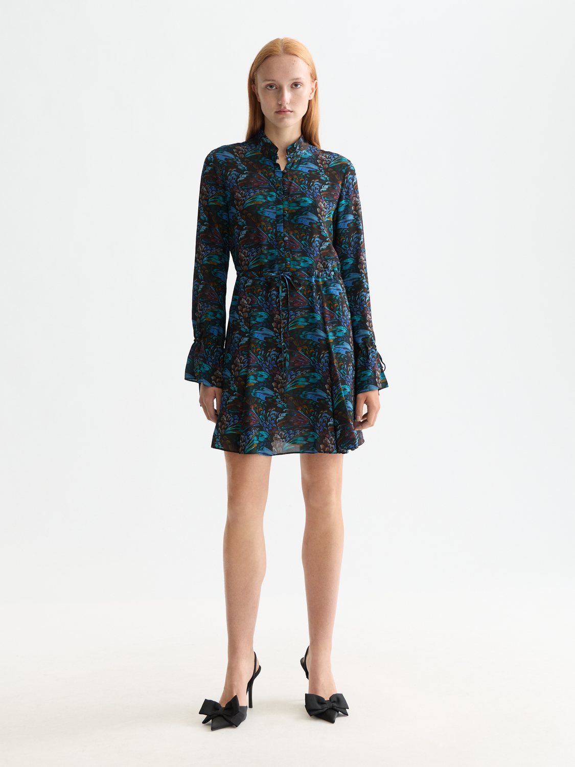 Printed mini dress by Scotch & Soda, featuring colorful floral patterns and a fitted silhouette, worn by a model.