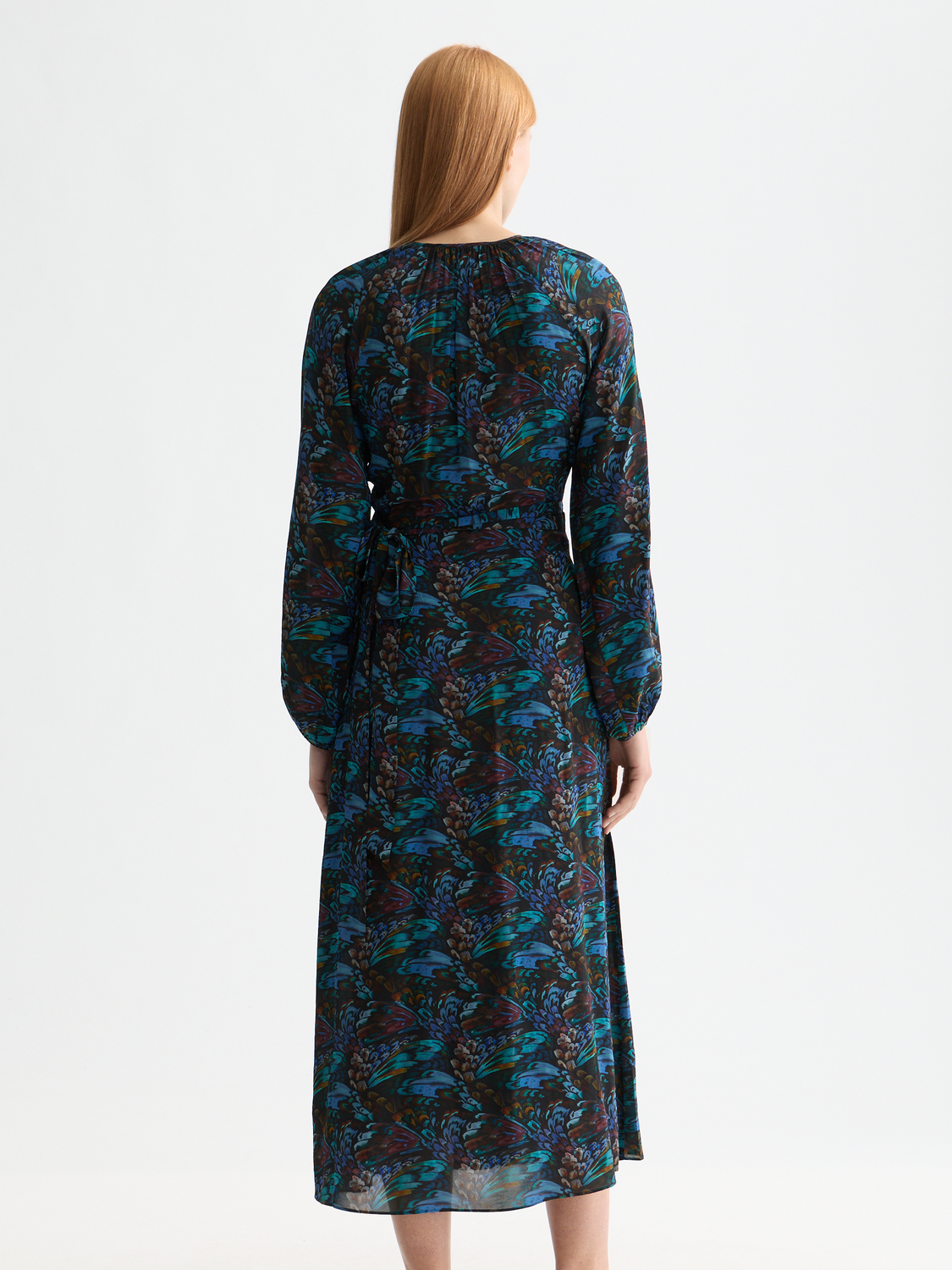 Black Scotch & Soda midi wrap dress with long sleeves and a fitted waist, displayed on a model against a neutral background.