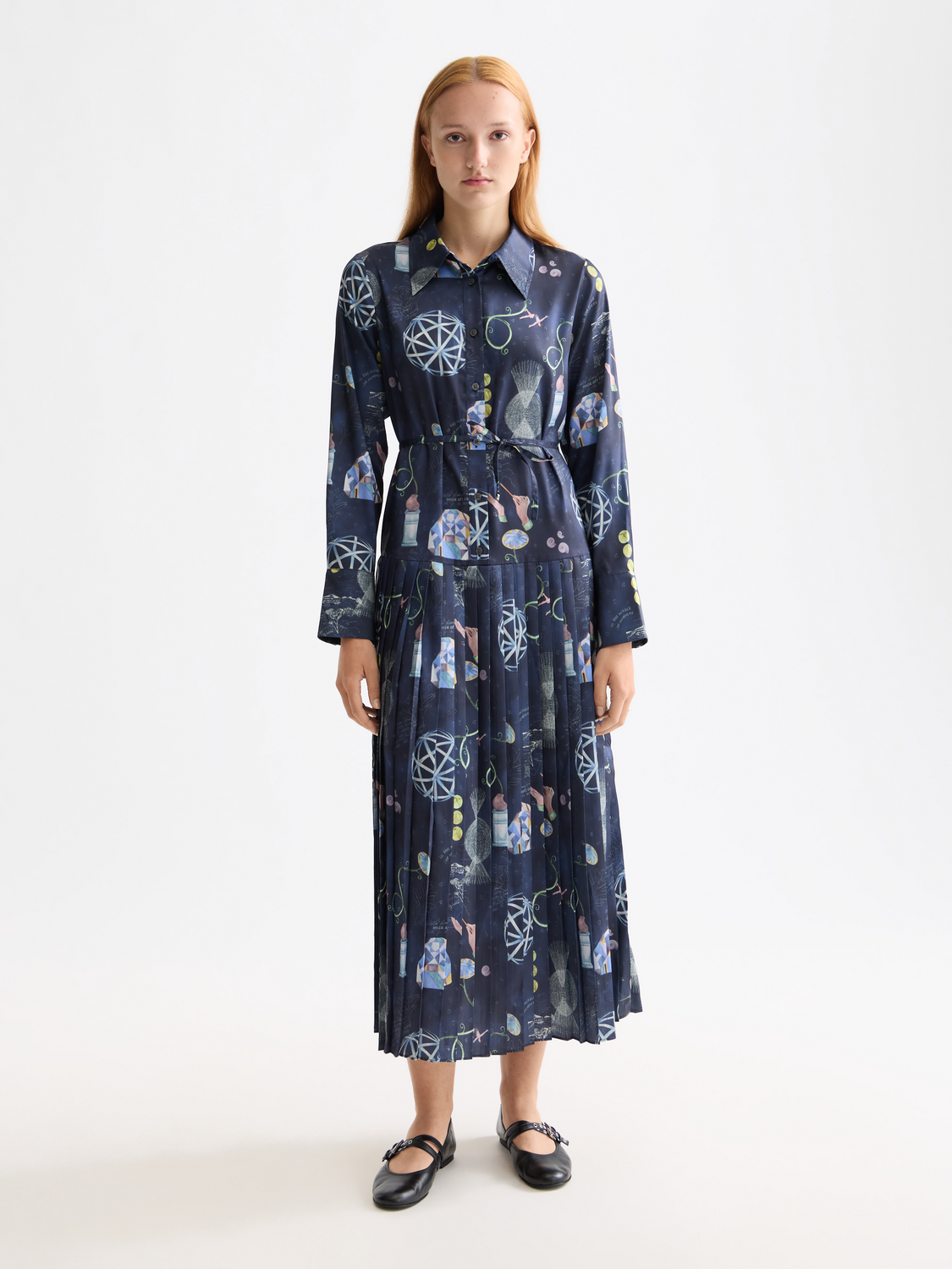 Scarlet pleated midi dress by Scotch & Soda featuring a flowy skirt and fitted bodice, shown on a model.