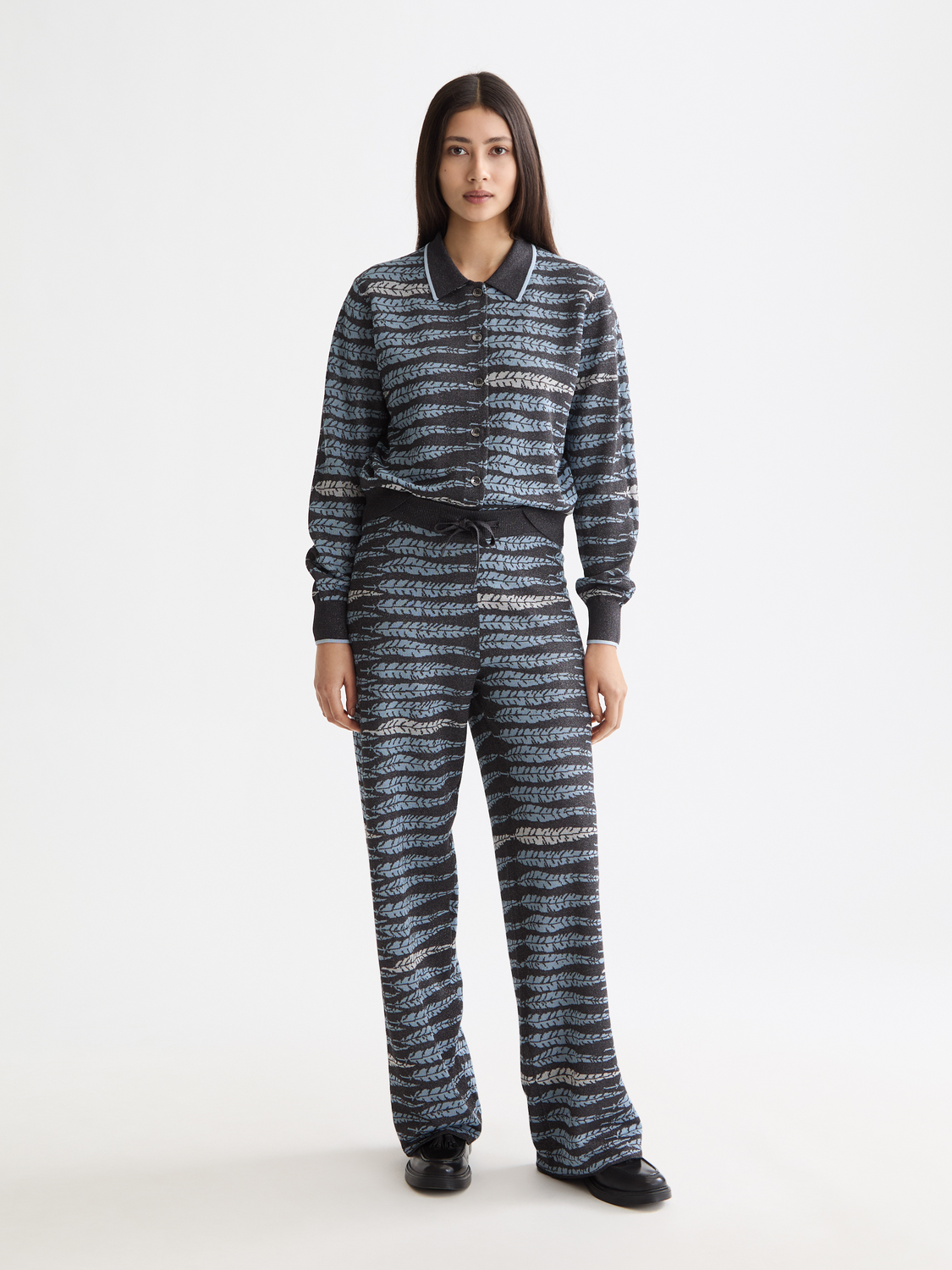 Black Lurex jacquard sweatpants by Scotch & Soda with a textured pattern and relaxed fit, shown on a model.