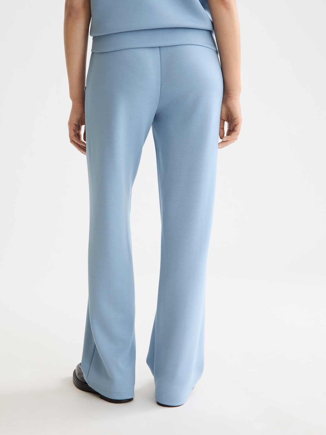 Black Scotch & Soda modal sweatpants with relaxed fit, shown from the back, featuring soft fabric and comfortable waistband.