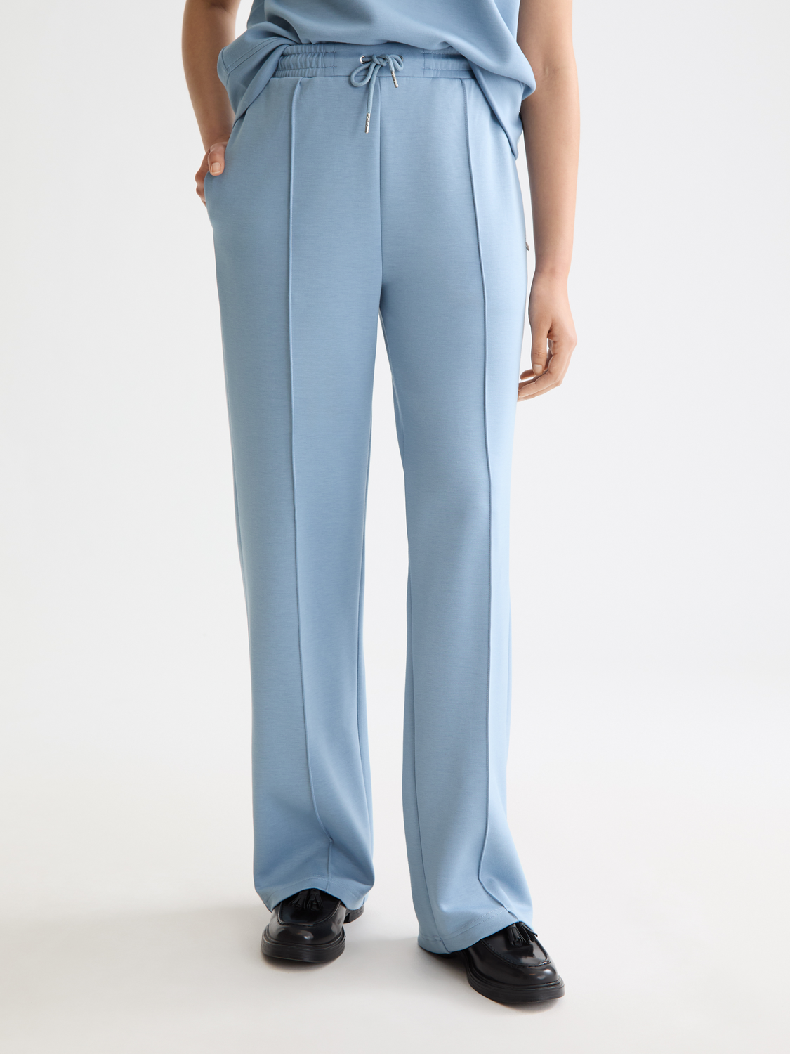 Gray modal sweatpants by Scotch & Soda, featuring a relaxed fit and soft fabric, shown on a model with side pockets.
