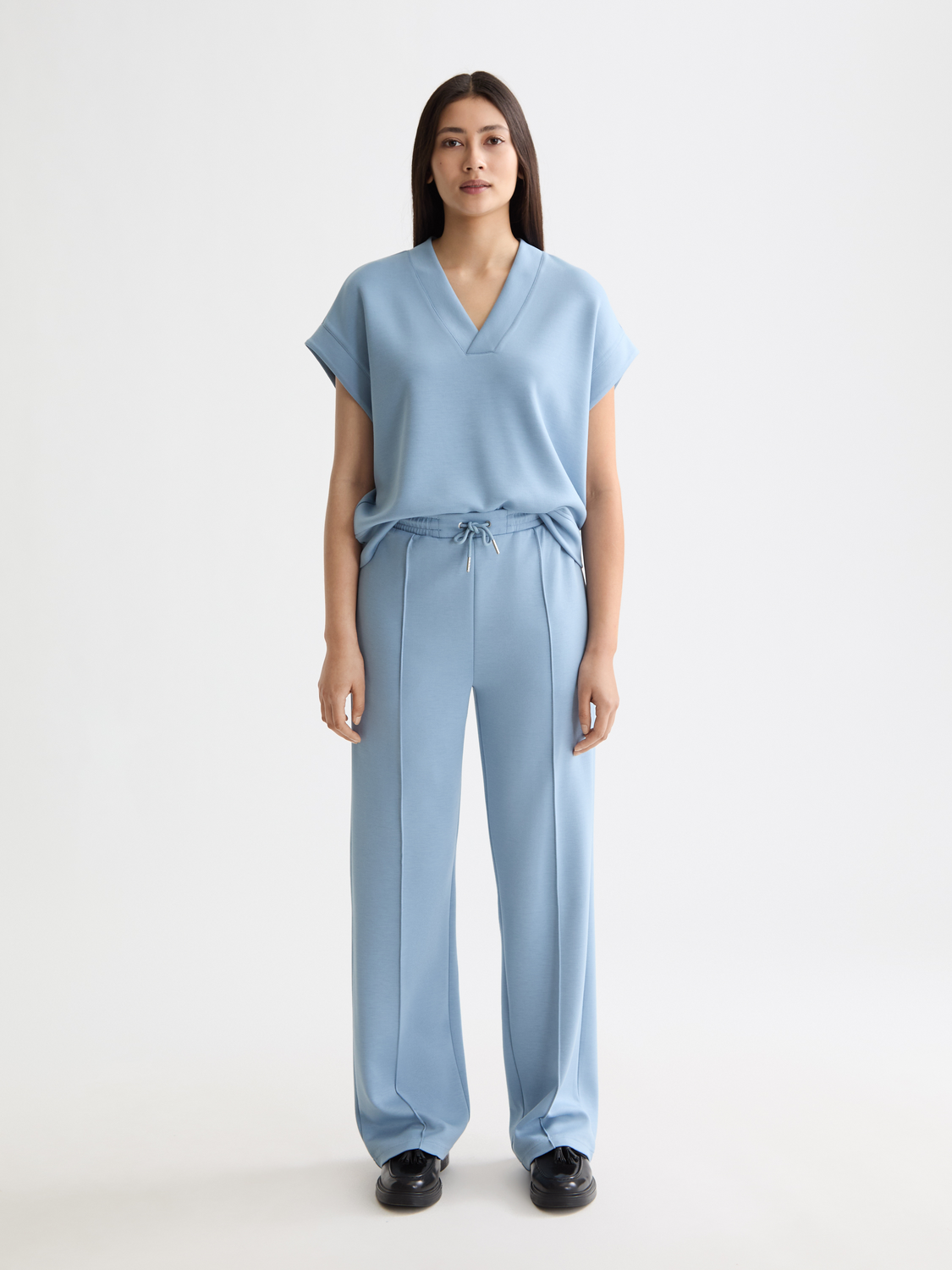 Gray SCOTCH & SODA modal sweatpants with elastic waistband and relaxed fit, shown on a hanger.