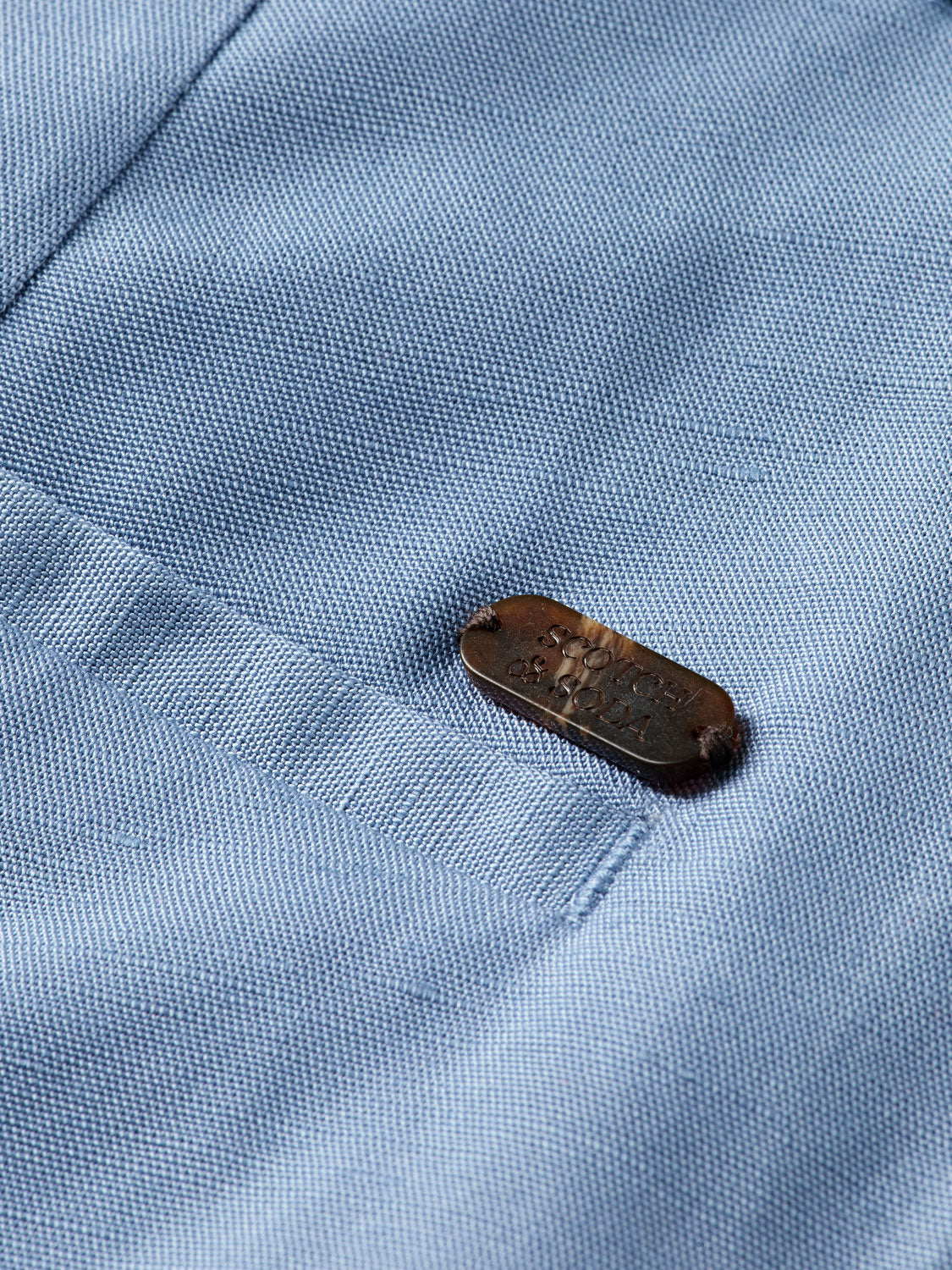 Wide-fit Edie pants by Scotch & Soda featuring a tailored design in durable fabric, shown in a neutral color.