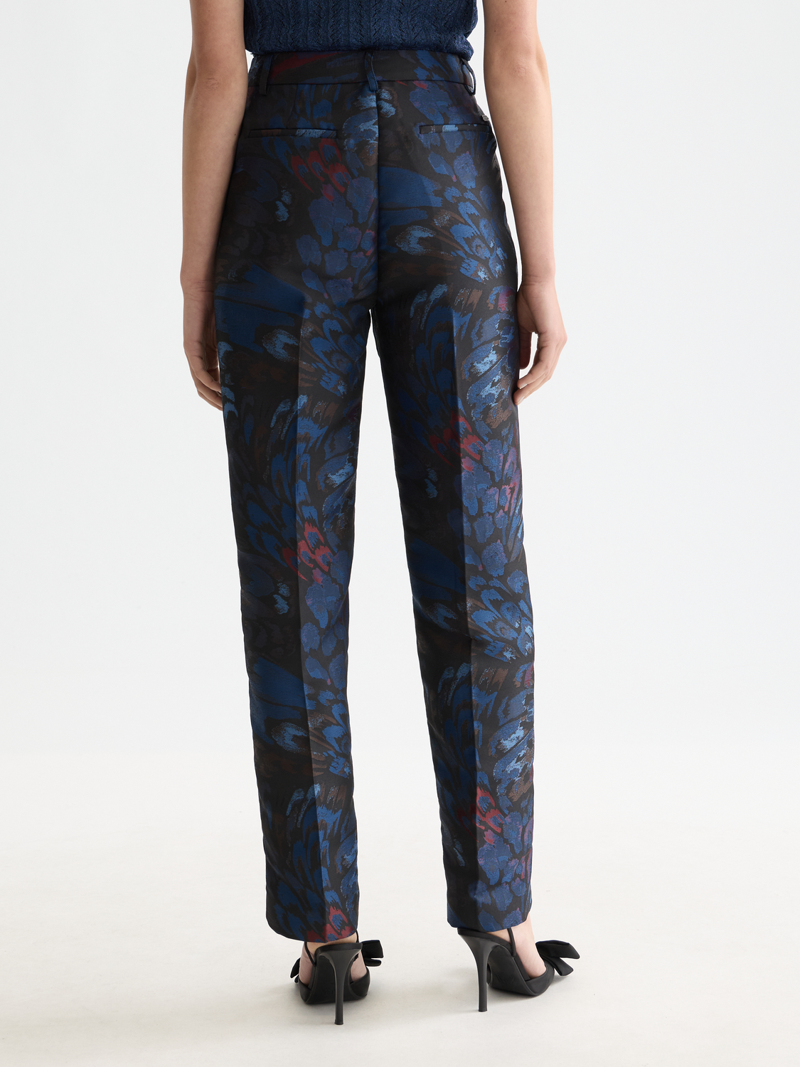 Black ripple jacquard pants by Scotch & Soda featuring a textured pattern and tailored fit, shown on a model.