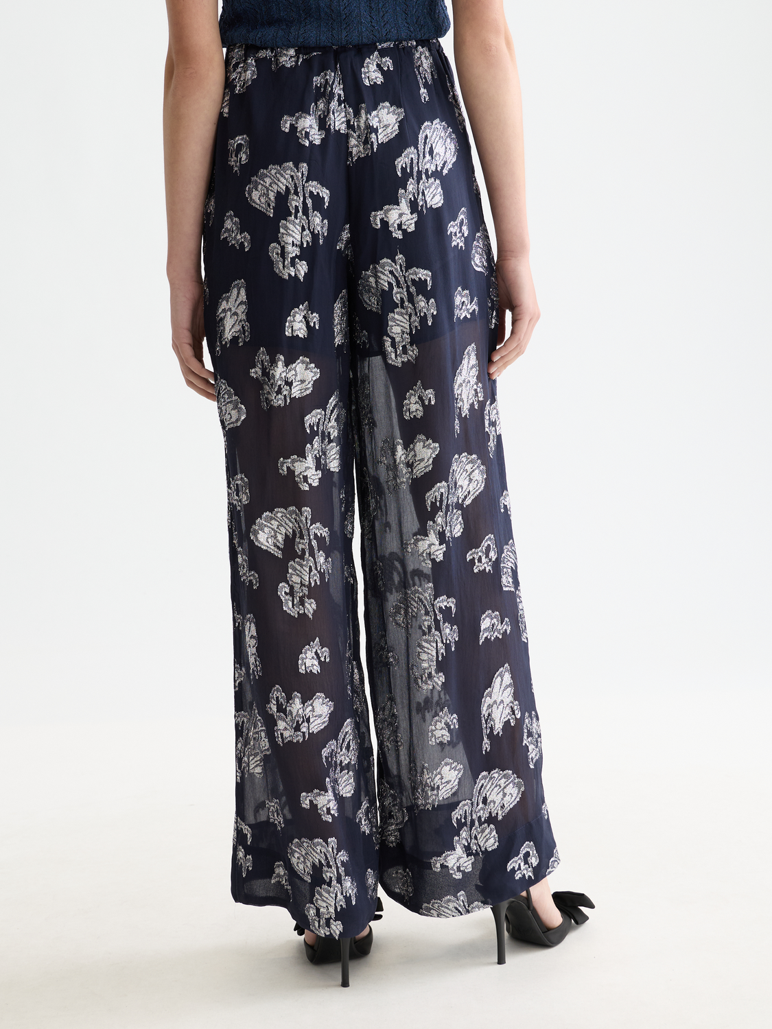 Eleni wide-fit pants by Scotch & Soda in dark denim fabric, shown from the back with a relaxed, wide-leg silhouette.