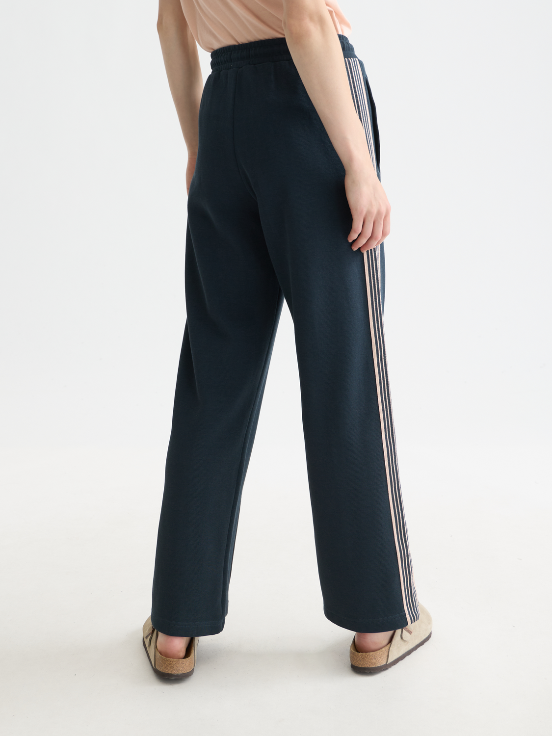 Black Scotch & Soda interlock sweatpants with a relaxed fit and elastic waistband, shown from the back.