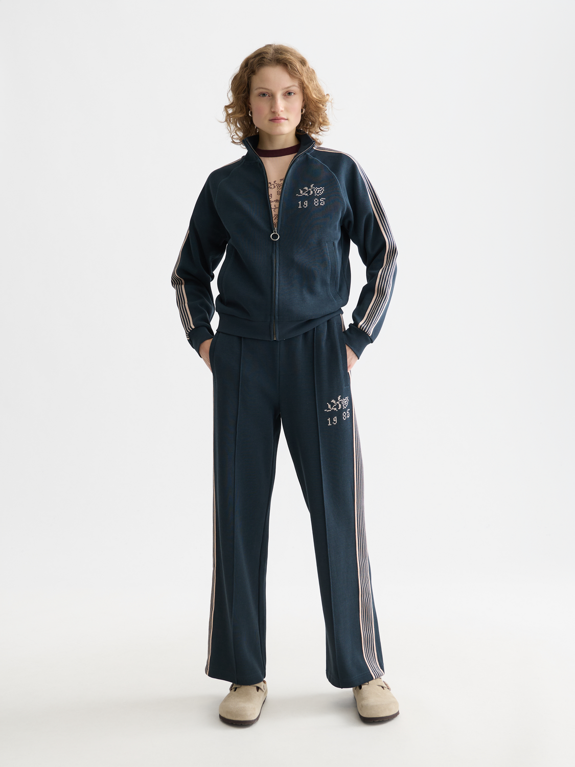 Blue Scotch & Soda interlock sweatpants with a relaxed fit, featuring elastic waistband and cuffs, shown on a model.