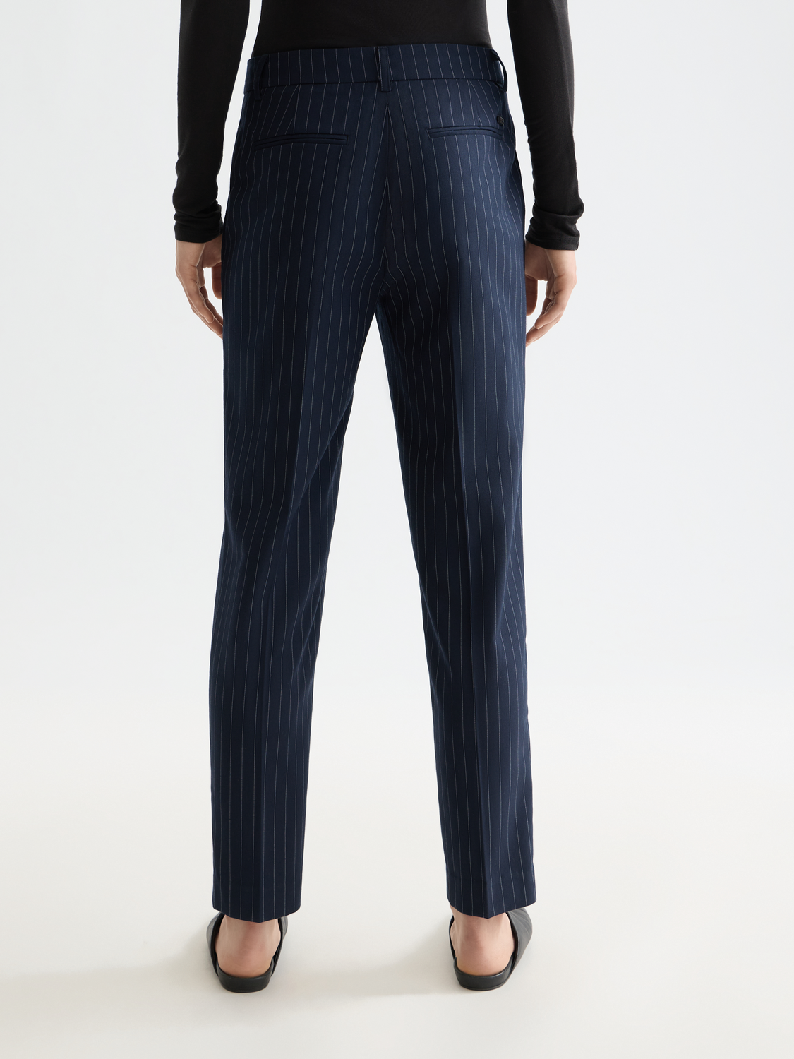 Scotch & Soda Lowry slim-fit pants in dark fabric, shown from back view with waistband and tailored fit.