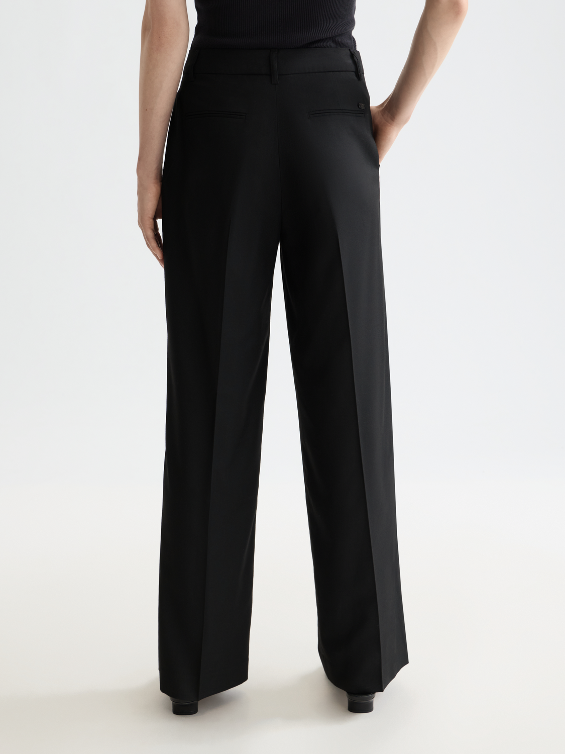 Wide-fit Edie pants by Scotch & Soda, shown from the back, in a relaxed style with a tailored fit and classic design.