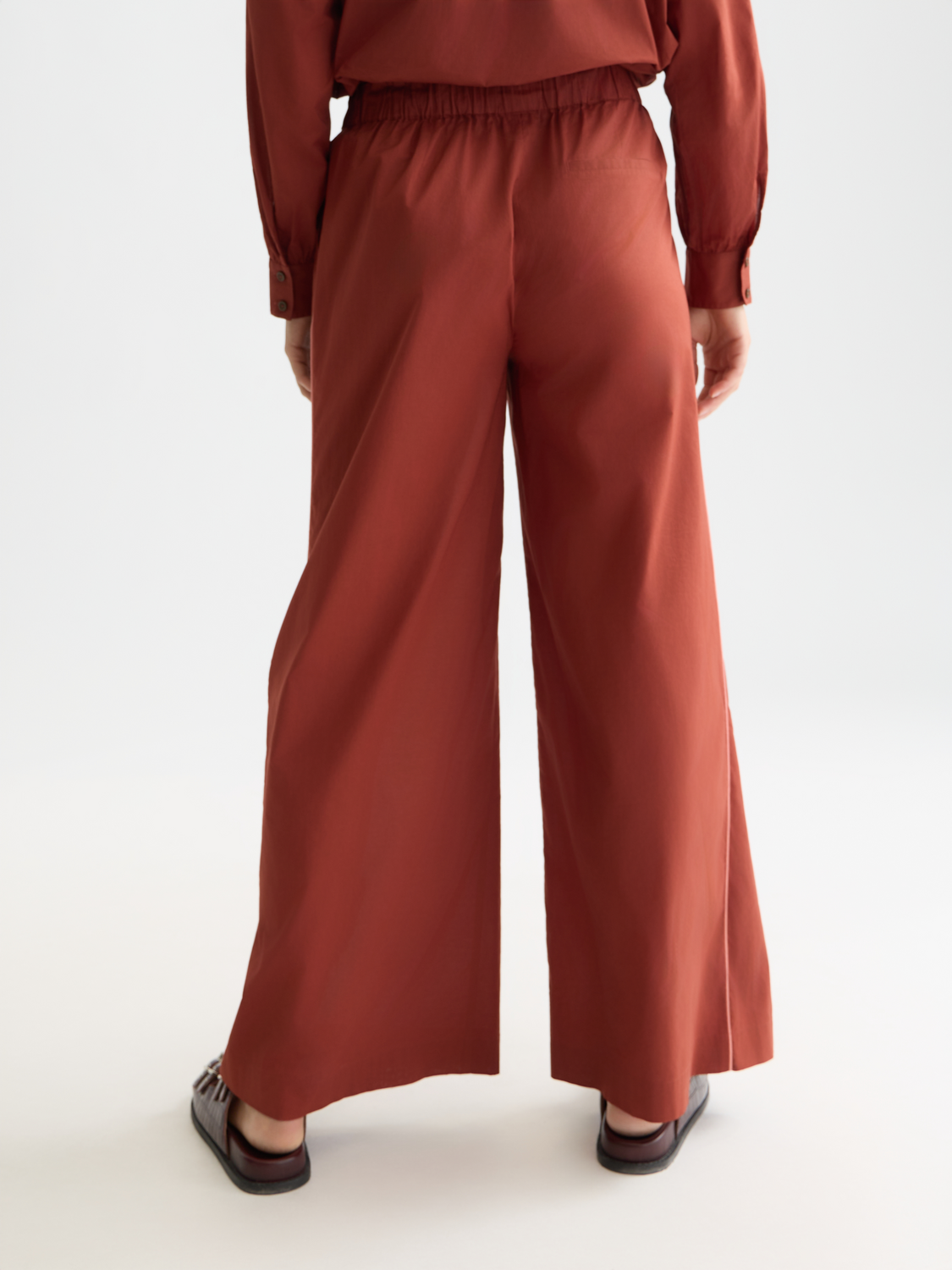 Wide-fit Eleni pants by Scotch & Soda featuring a relaxed silhouette and back pocket detail, shown from the rear.