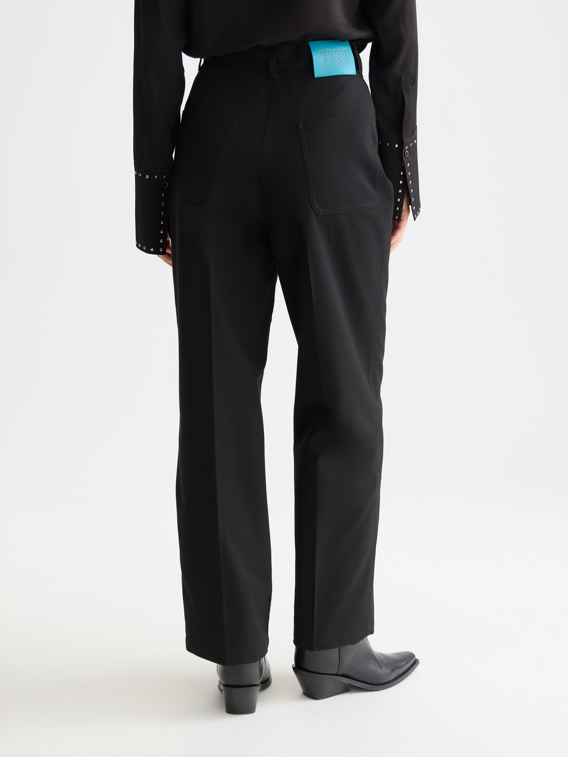 Raine wide-fit pants by Scotch & Soda shown from the back, featuring relaxed fit and stylish design in neutral fabric.