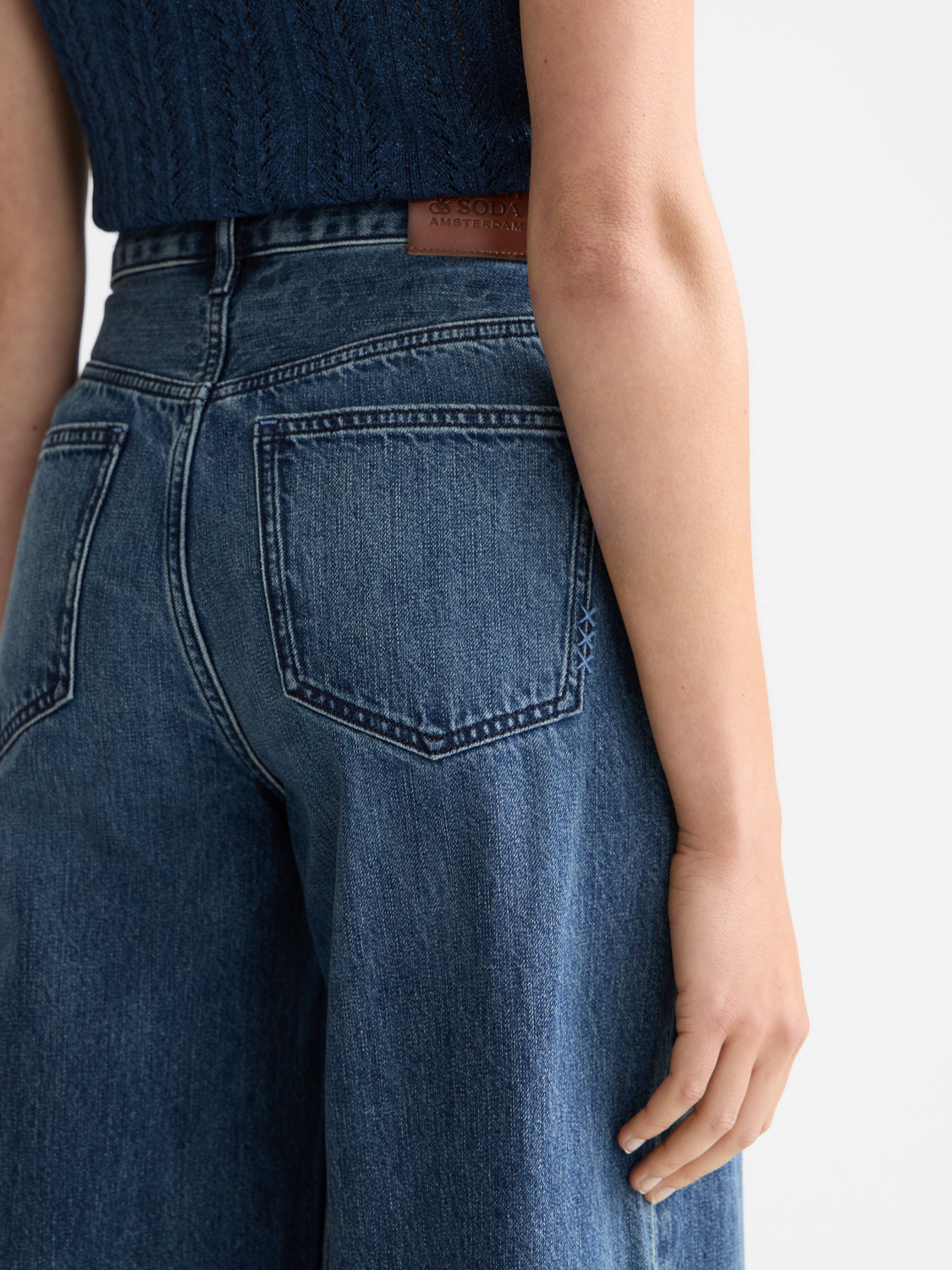 Scotch & Soda Wave wide-fit denim jeans displayed on a model, showcasing the relaxed fit and classic denim style.