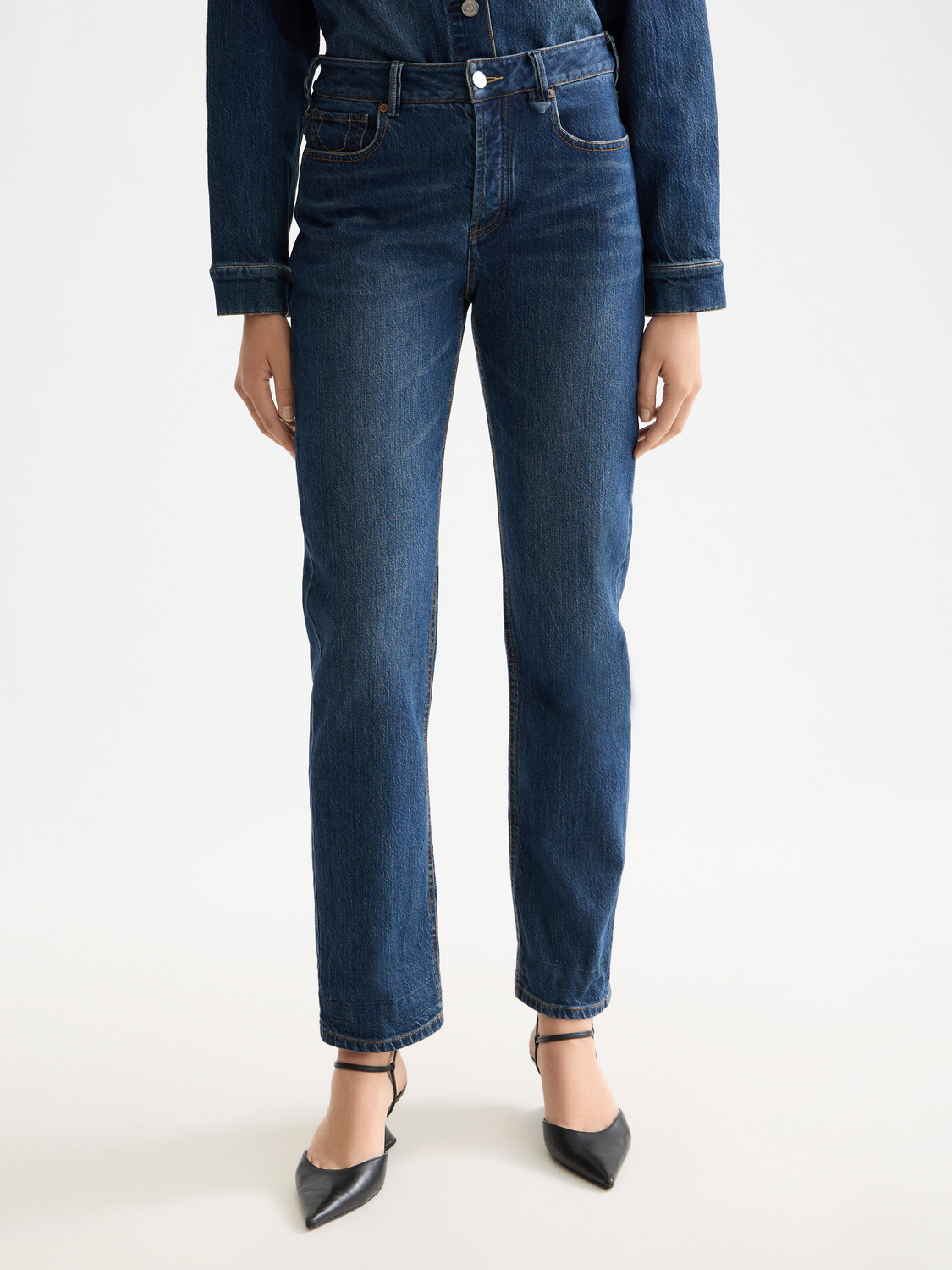 Sky straight-fit denim jeans by Scotch & Soda displayed on a model, showing classic five-pocket design and light wash finish.
