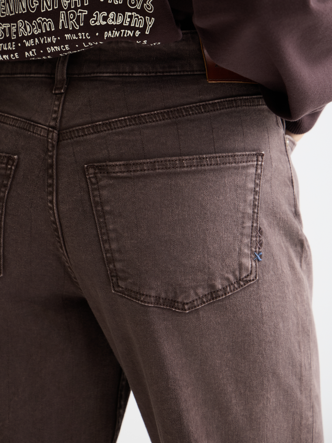 Sky straight-fit denim jeans by Scotch & Soda displayed on a model, featuring classic five-pocket design and light wash.
