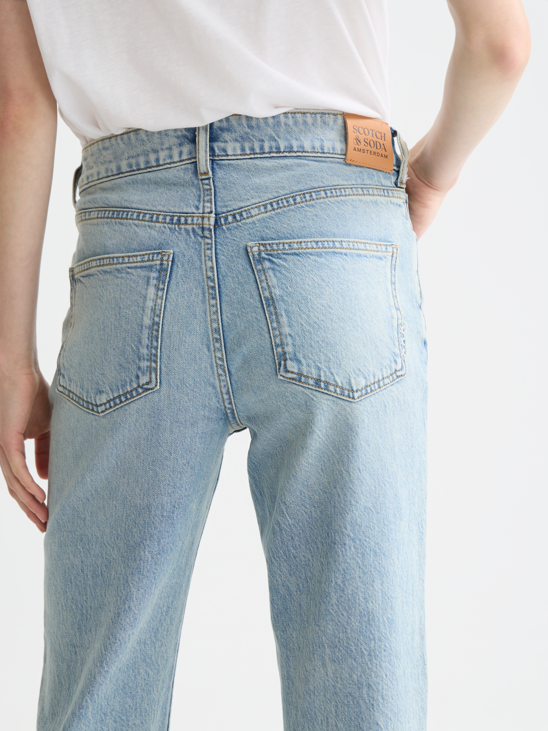 Sky straight-fit denim jeans by Scotch & Soda, featuring classic five-pocket design and a light blue wash.
