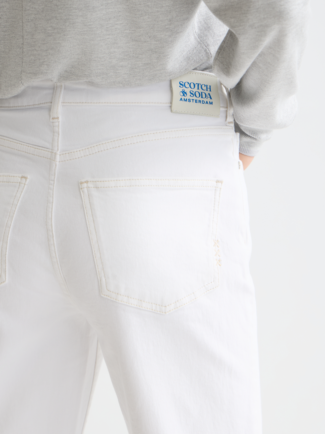 Sky straight-fit denim jeans by Scotch & Soda, shown on a model, featuring classic five-pocket design and medium wash finish.