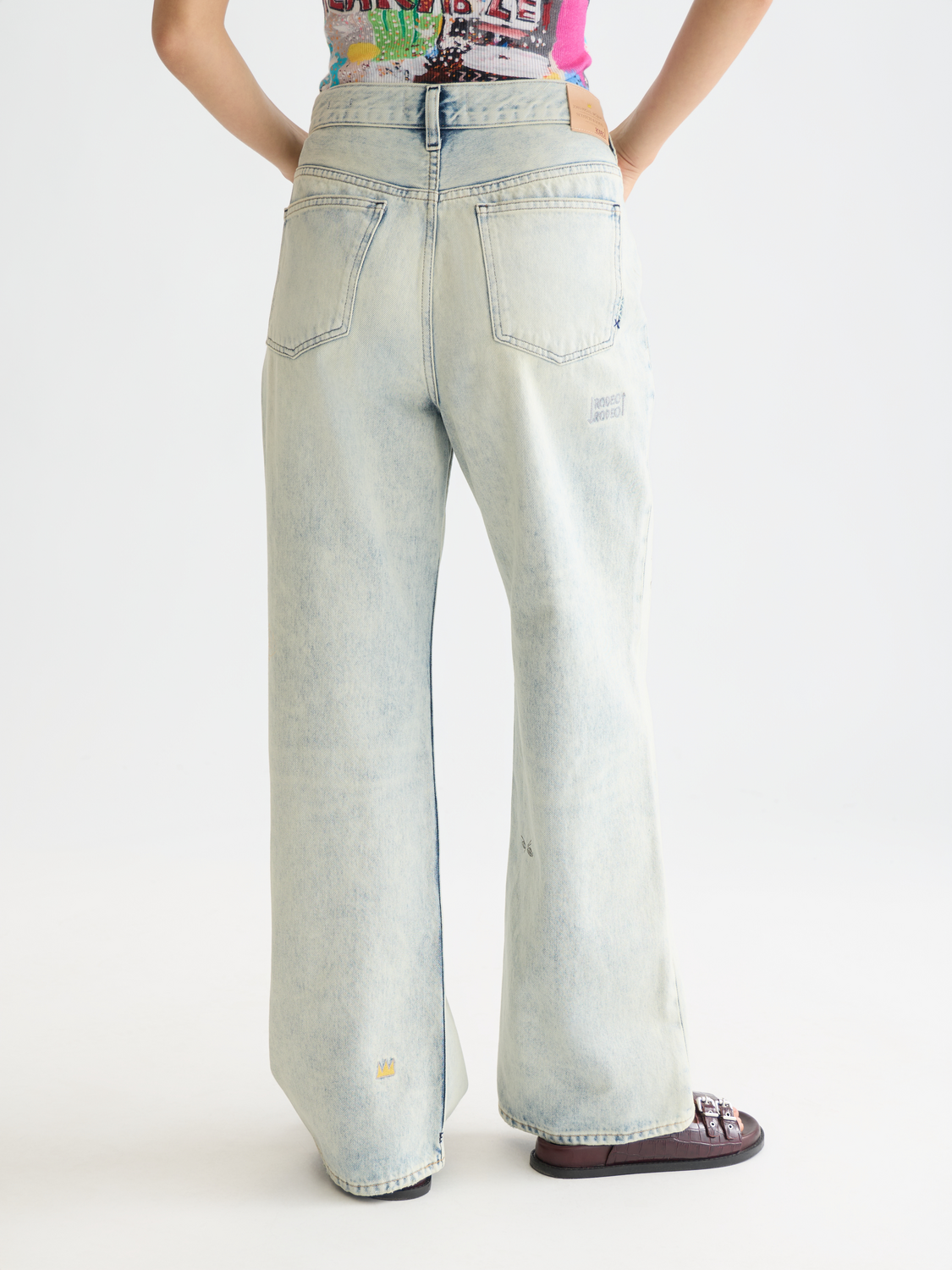 Deep loose-fit denim jeans by Scotch & Soda featuring S&S x Basquiat design, shown from the back with a relaxed fit.