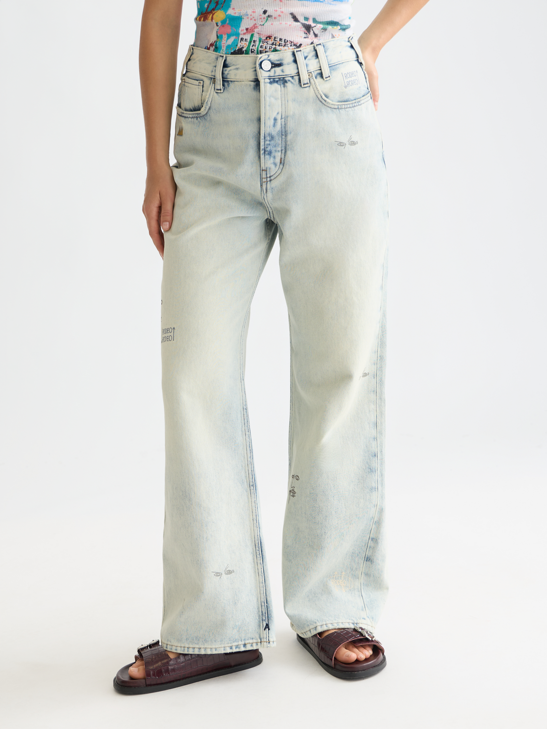 Deep loose-fit denim jeans by Scotch & Soda featuring S&S x Basquiat collaboration, shown in a front view with classic denim texture.
