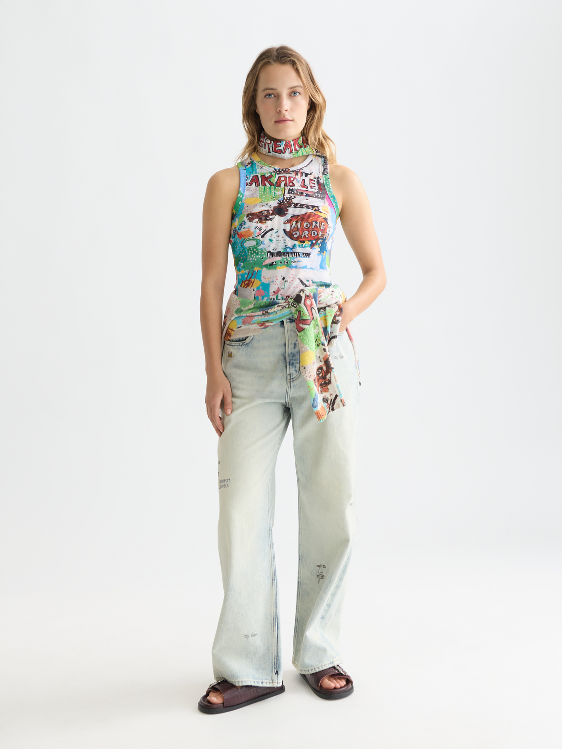 Light blue loose-fit denim jeans from S&S x Basquiat collection by Scotch & Soda, featuring a relaxed style and artistic detailing.