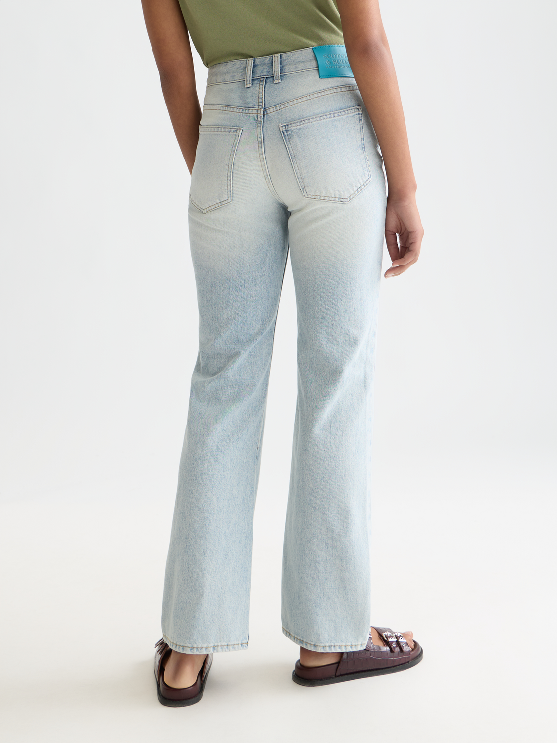 Dark blue Scotch & SODA glow bootcut denim jeans with back pockets, fitted style, and subtle fading for a casual look.