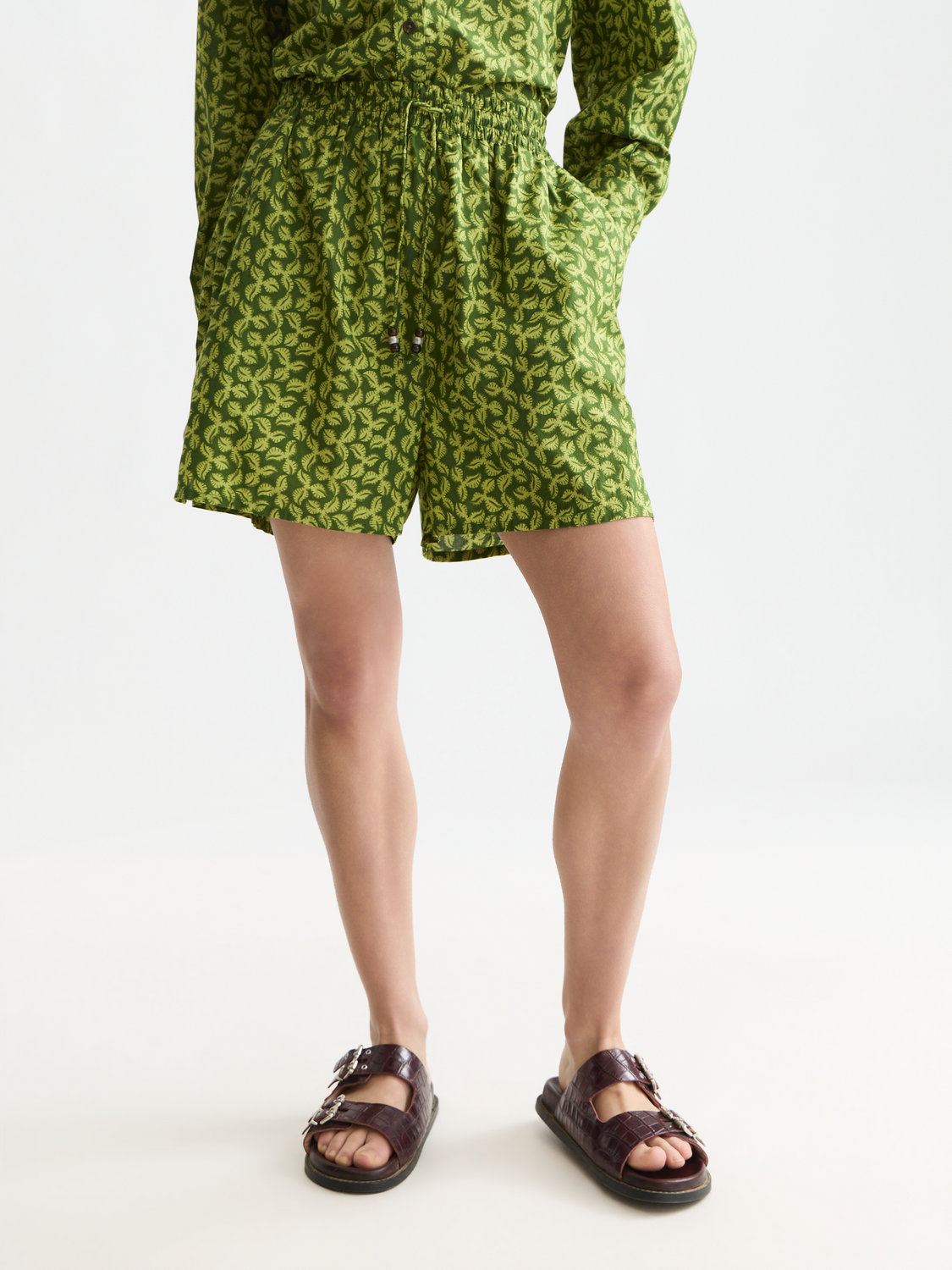 Printed shorts by Scotch & Soda featuring vibrant floral patterns and a relaxed fit, shown on a model.