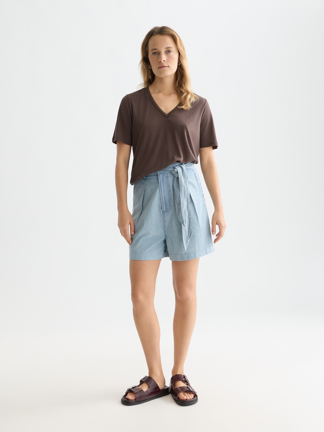 Blue denim Scotch & Soda shorts for women, featuring a classic fit and stylish indigo wash, shown on a model.