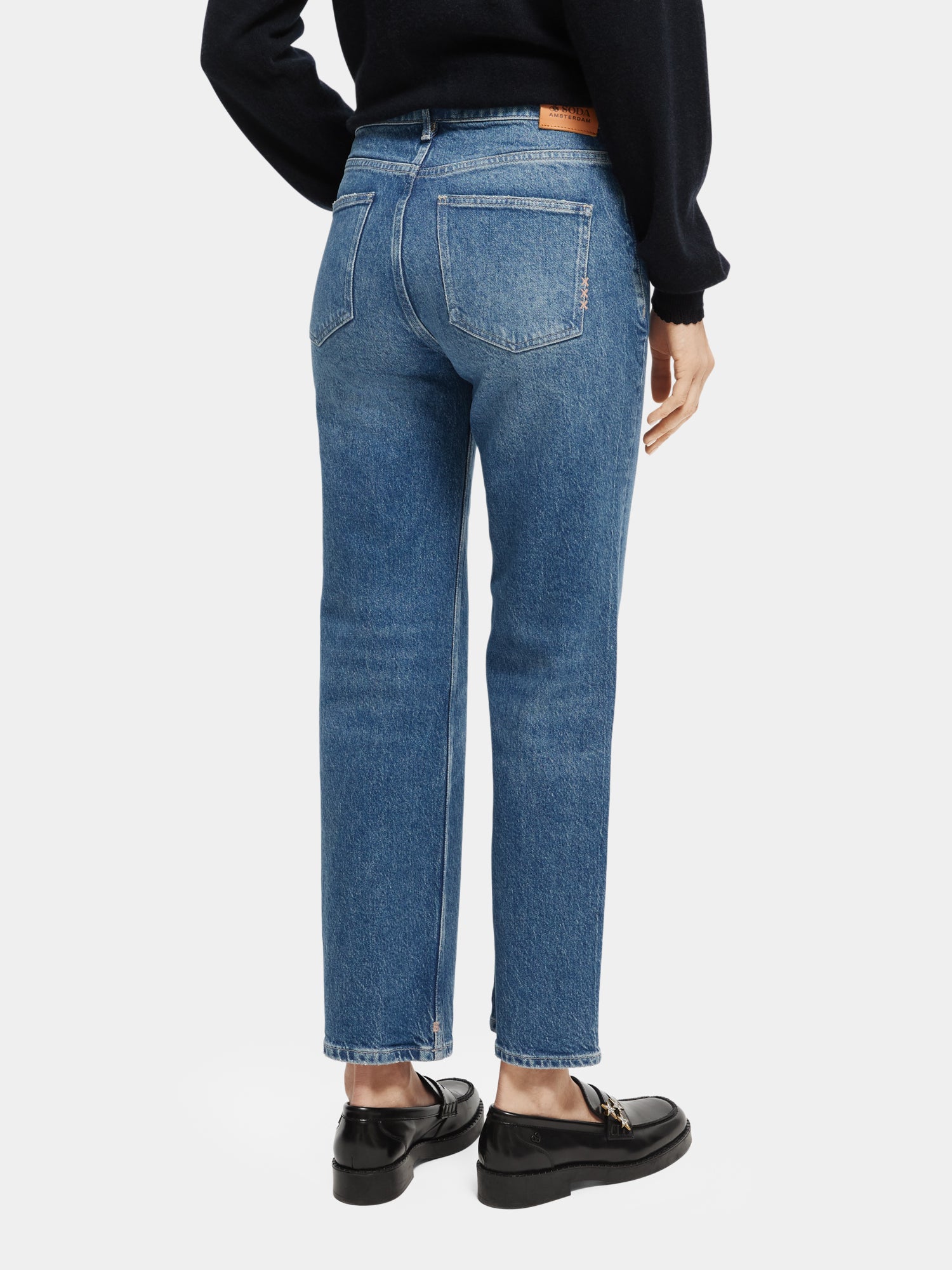 Sky straight fit denim jeans by Scotch & Soda displayed from the back, showing classic blue wash and tailored fit.