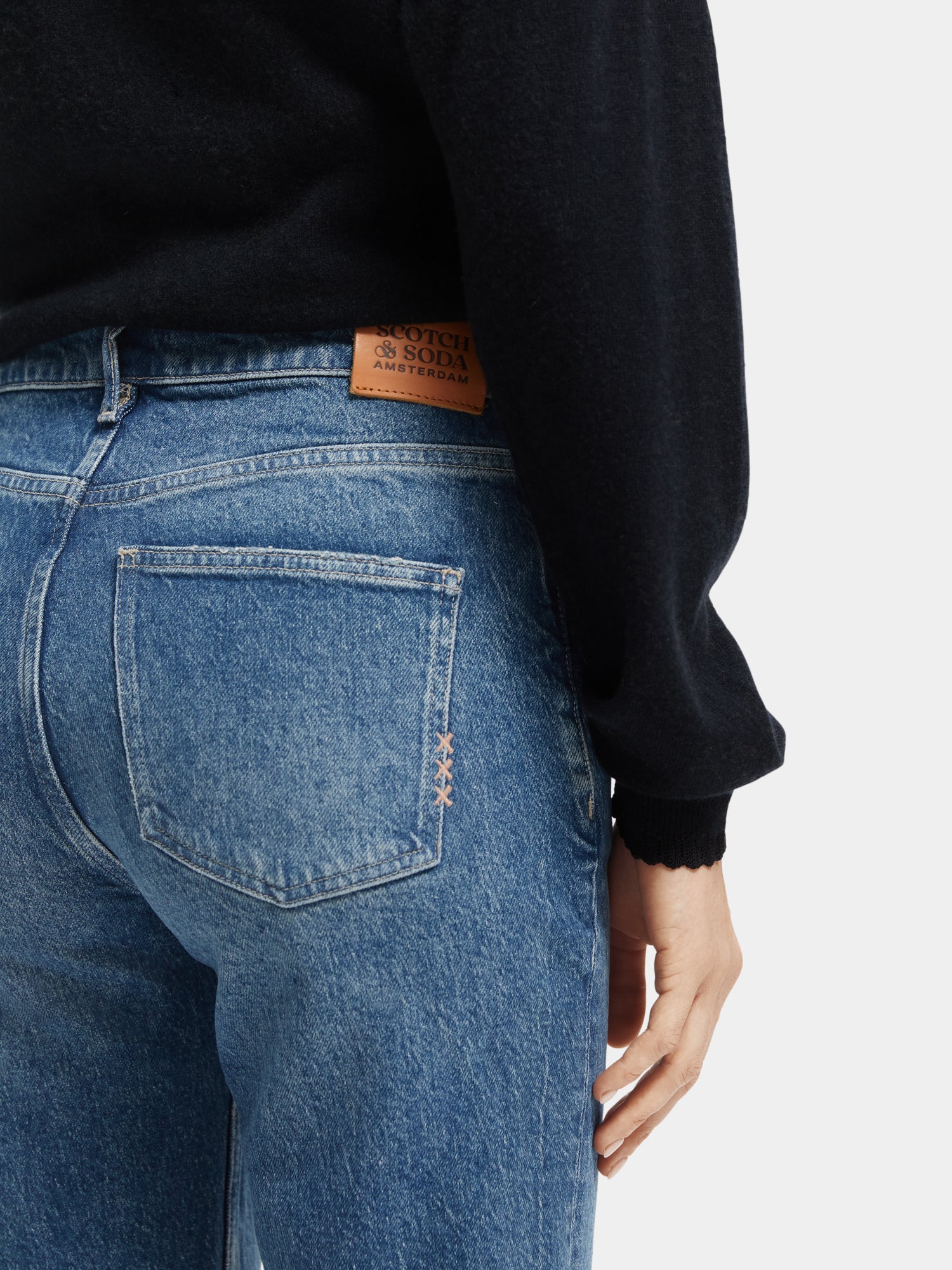 Sky straight fit denim jeans by Scotch & Soda, showcasing classic blue jeans with a straight leg cut and detailed stitching.
