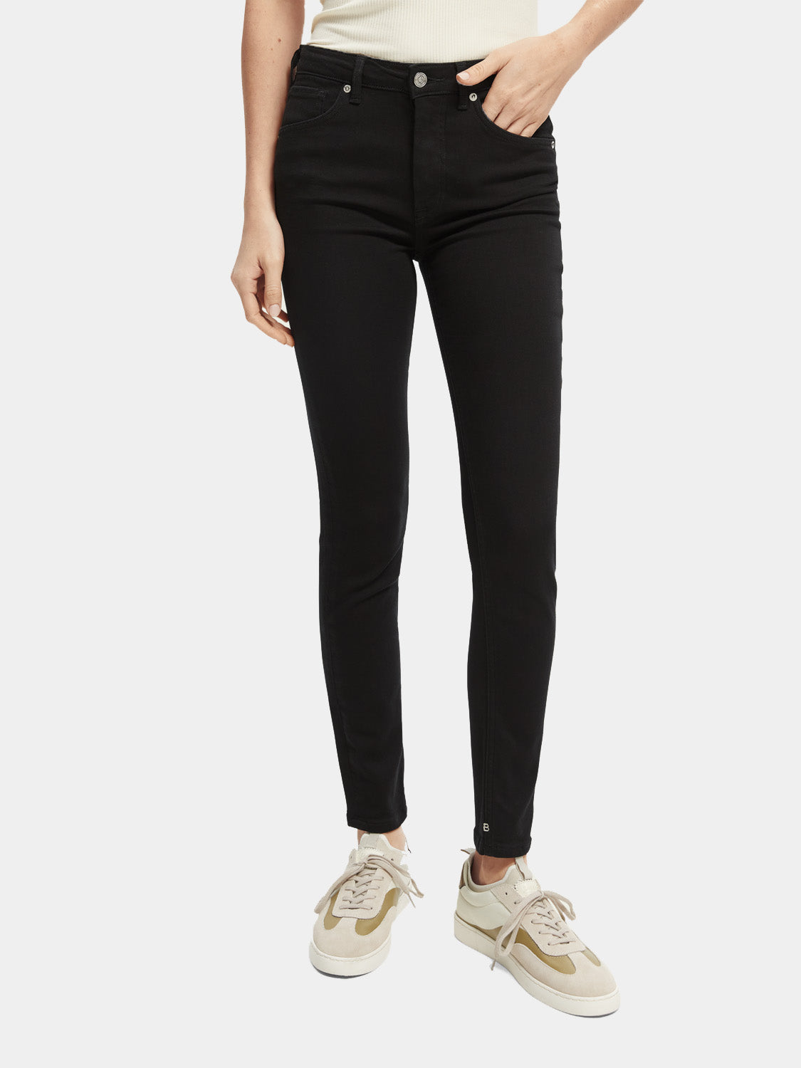 Pair of Scotch & Soda skinny fit denim jeans shown on a model, featuring a classic blue wash and slim silhouette.