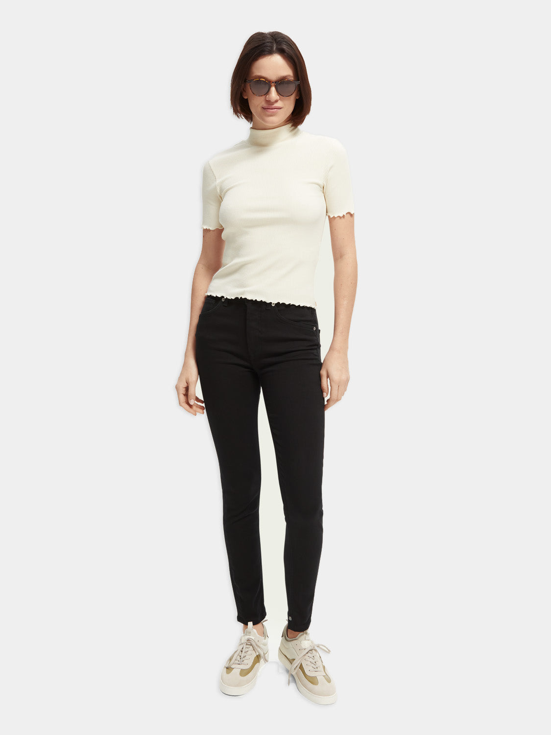 Skinny fit denim jeans by Scotch & Soda shown on a model, featuring a classic blue wash and slim silhouette.