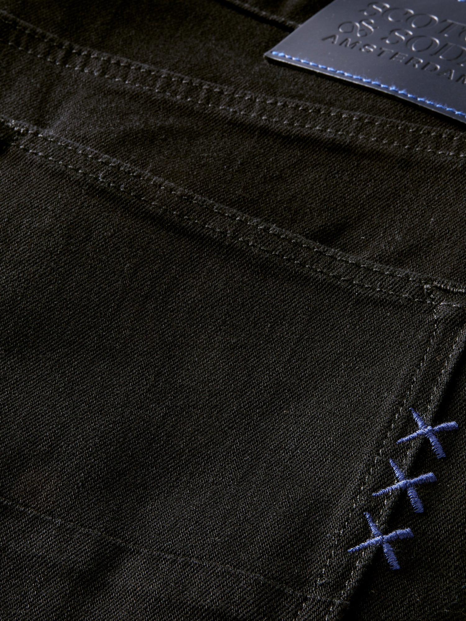 Scotch & Soda Ralston slim fit denim jeans with classic five-pocket style and dark wash, displayed flat on a white background.