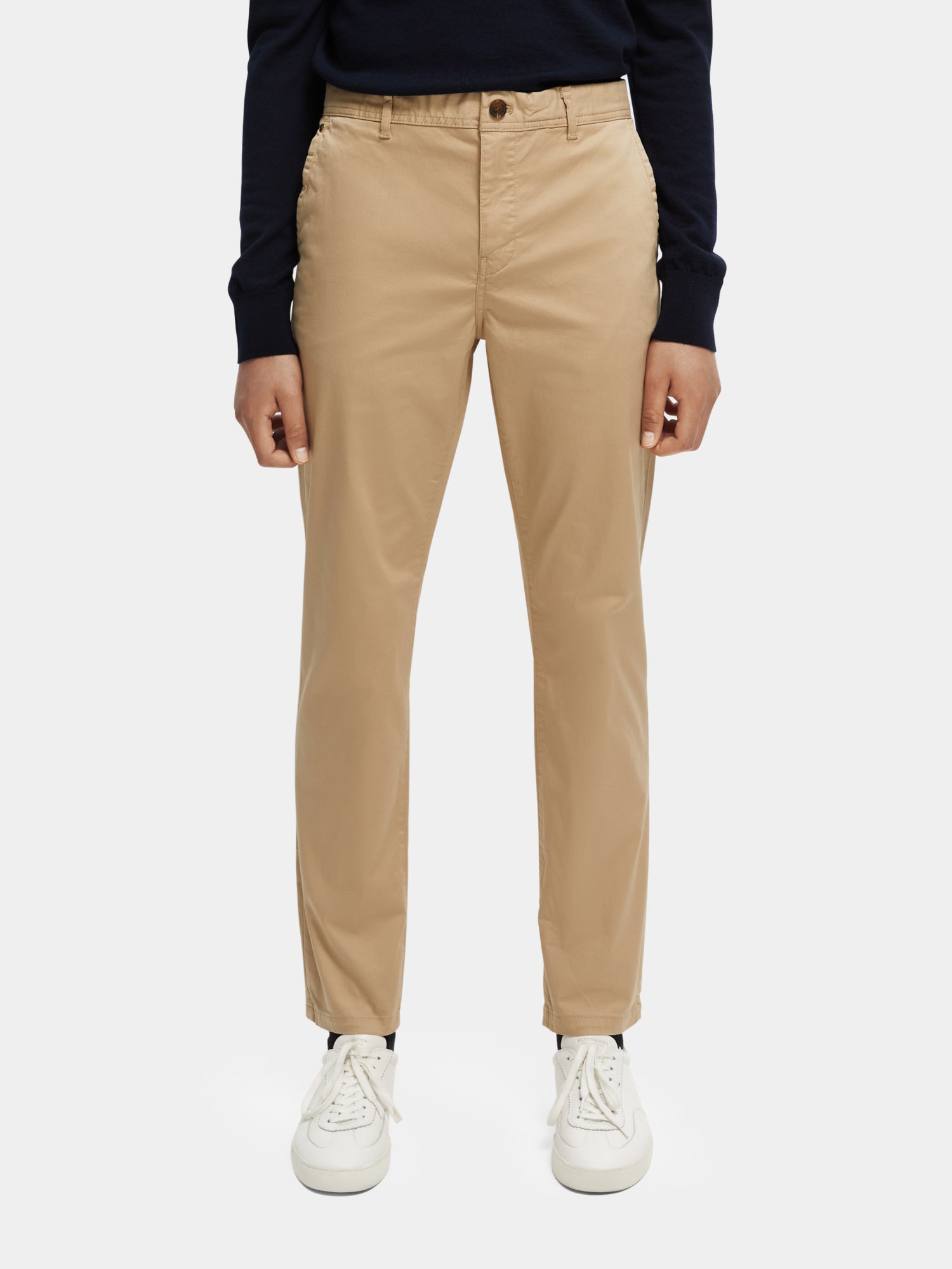 Stuart slim fit chinos by Scotch & Soda, beige pants with tailored fit, front pockets, and belt loops, on a neutral background.