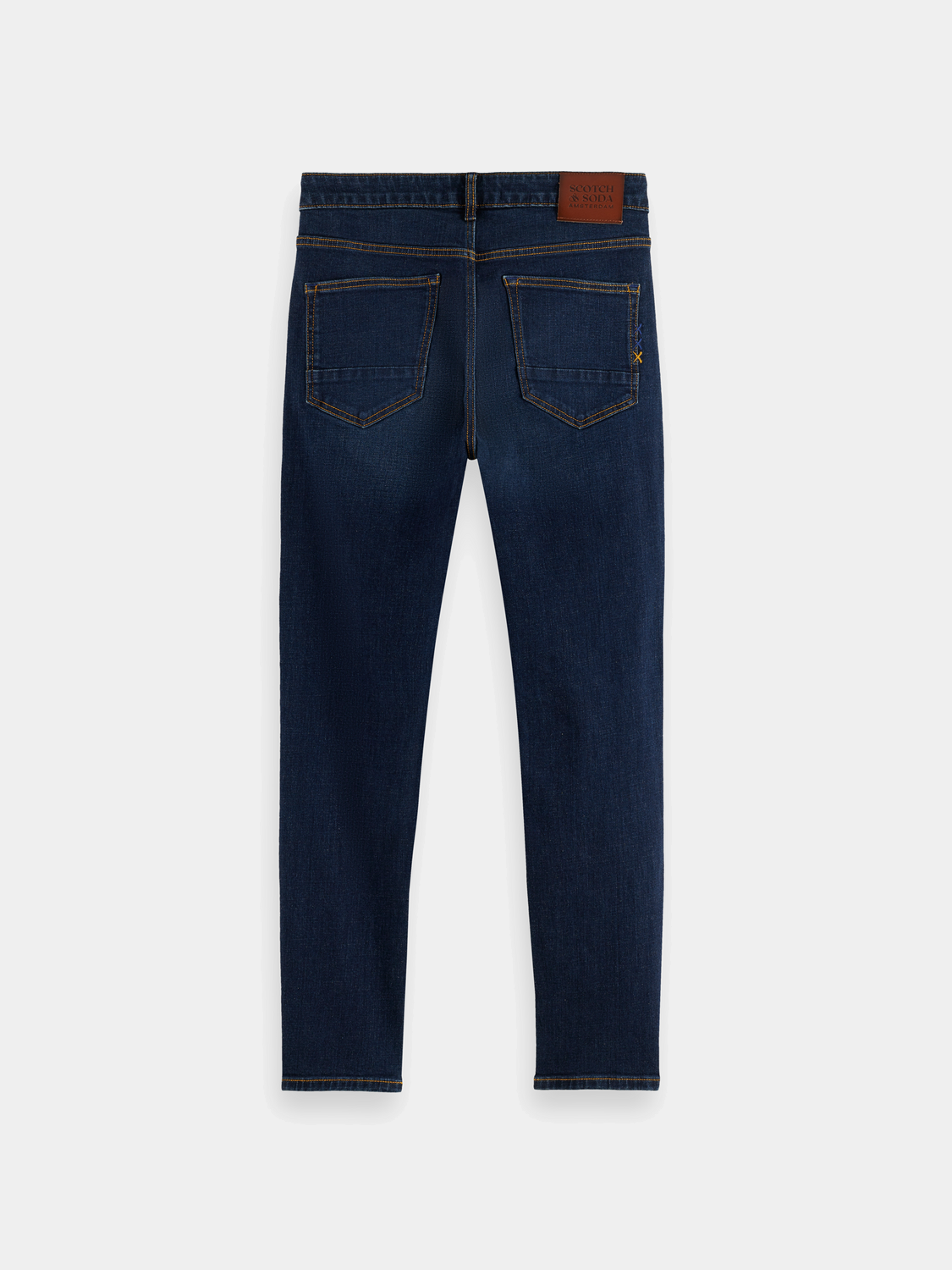 Dark blue Scotch & Soda skim skinny-fit denim jeans shown on a hanger with front pockets and a slim silhouette.