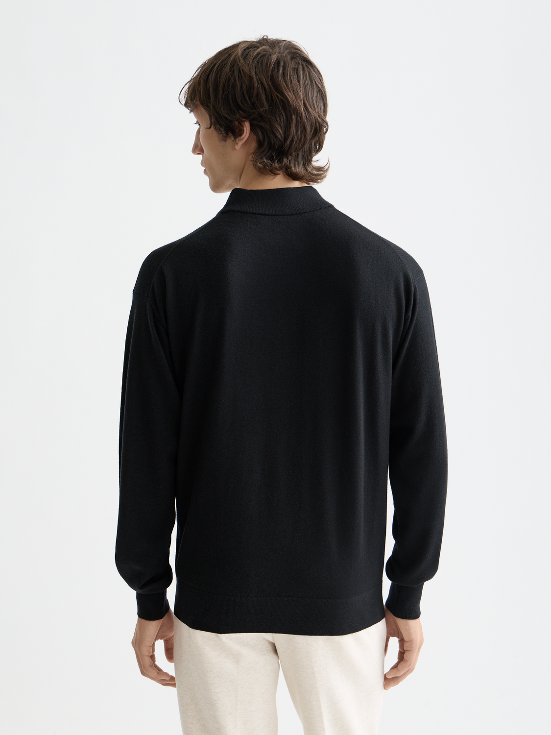 Navy knit mock neck sweater from SCOTCH & SODA with ribbed collar and long sleeves, displayed on a plain background.