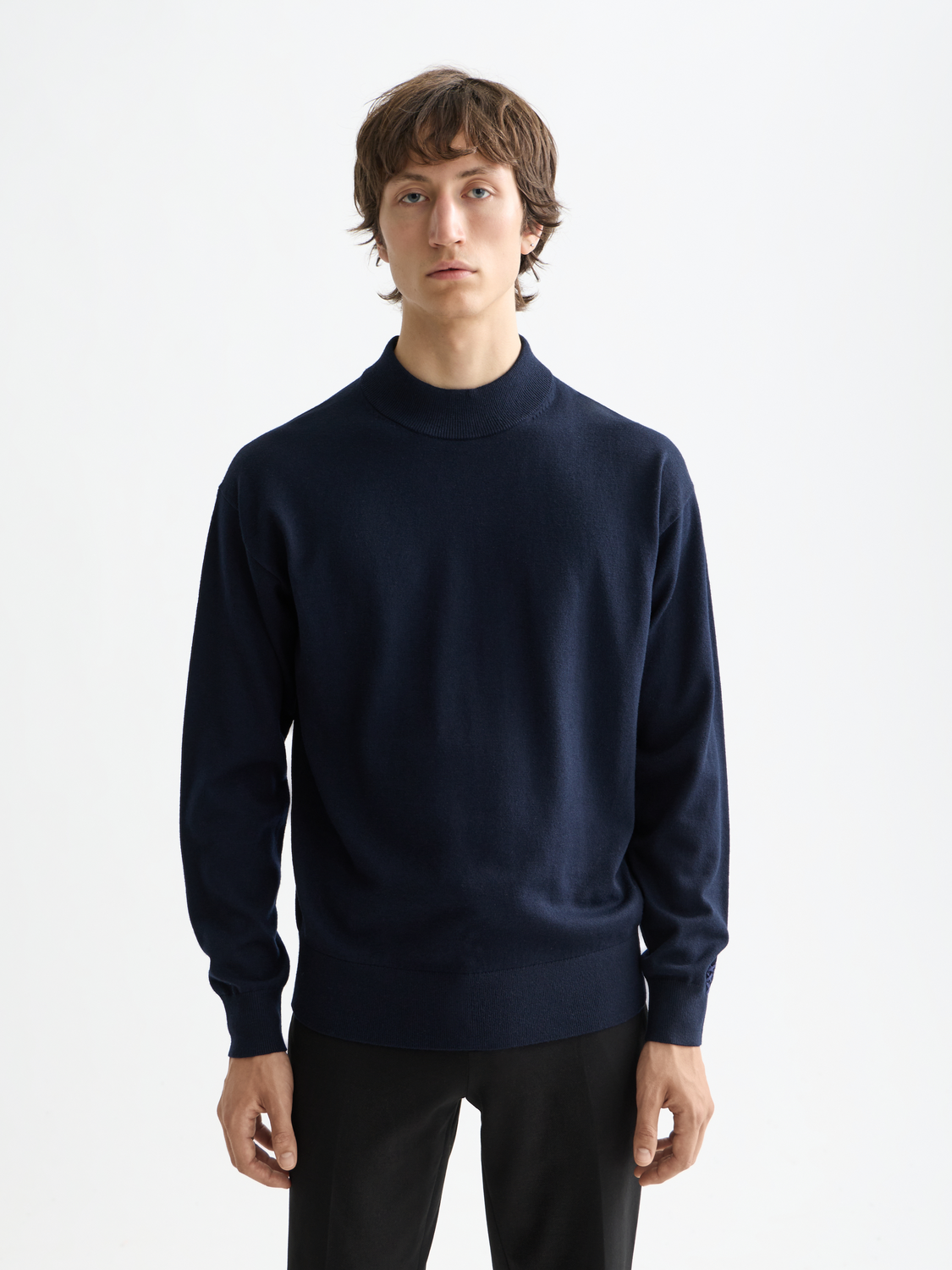 Cream knit mock neck sweater from Scotch & Soda with ribbed collar and long sleeves, displayed flat on a white background.