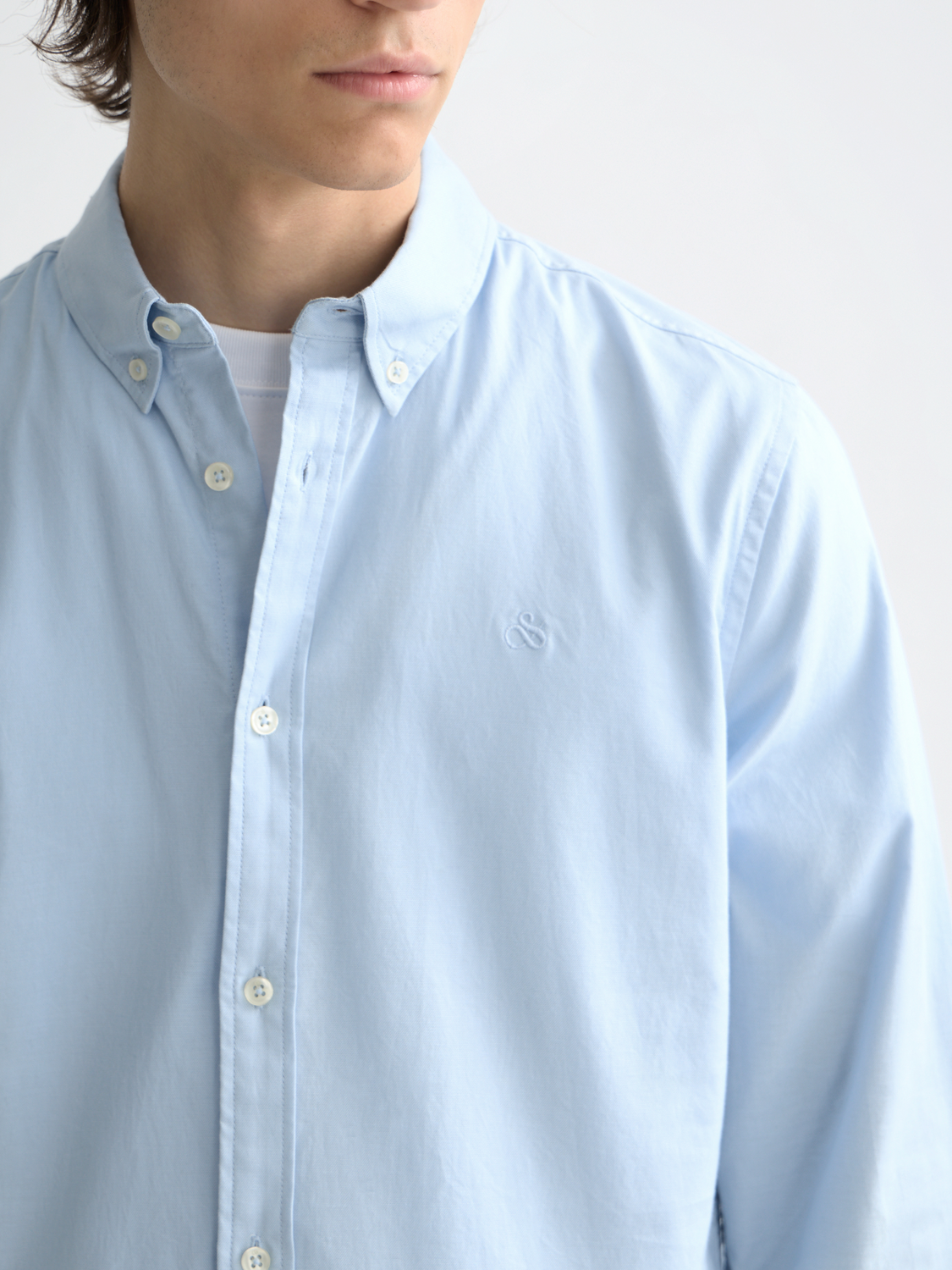 Long-sleeve Oxford shirt by Scotch & Soda featuring a classic button-down design and a patterned fabric in blue and white tones.