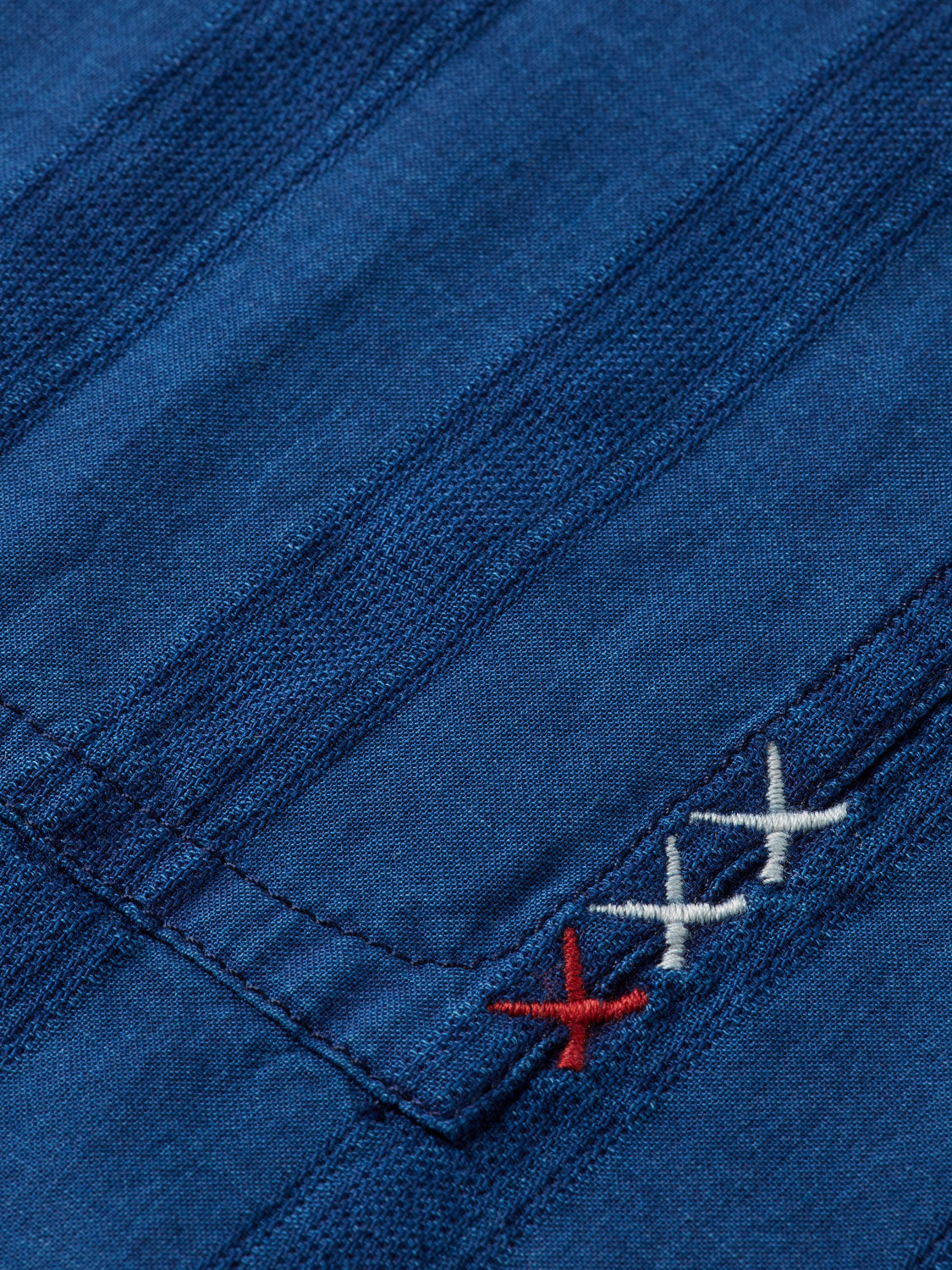 Textured indigo Scotch & Soda long-sleeve shirt with button collar and relaxed fit, displayed on a hanger.