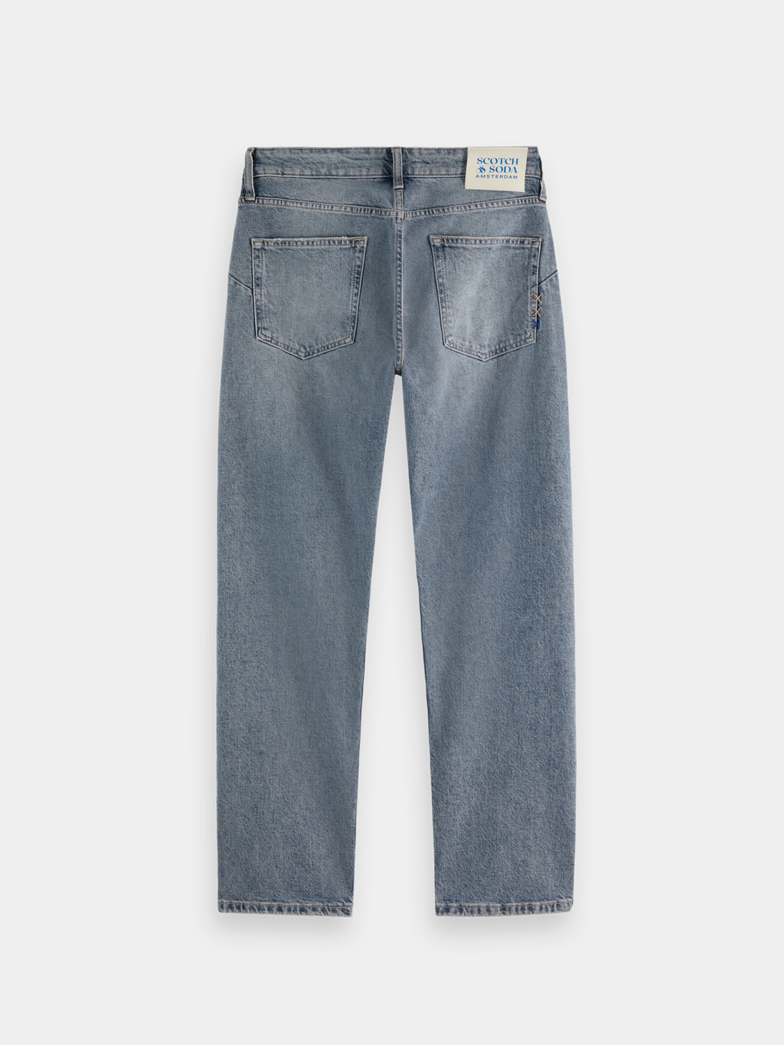 Dark blue Scotch & Soda Zee straight-fit denim jeans hanging on a rack with visible stitching and classic five-pocket design.