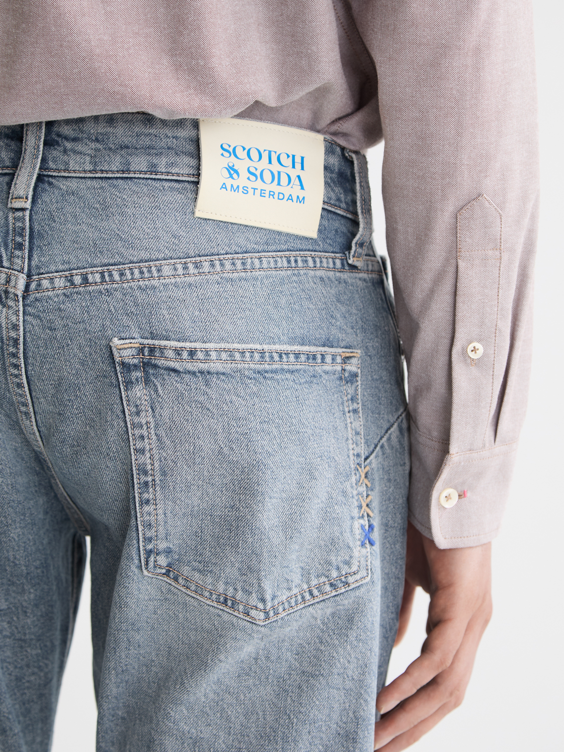 SCOTCH & SODA Zee straight-fit denim jeans, showing classic blue denim fabric and tailored fit with front and back pockets.