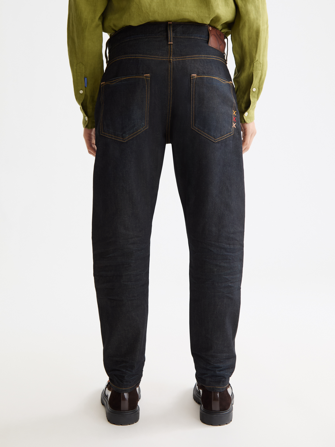 Back view of Scotch & Soda Dean tapered denim jeans showing fit and dark wash with subtle fading and stitching details.