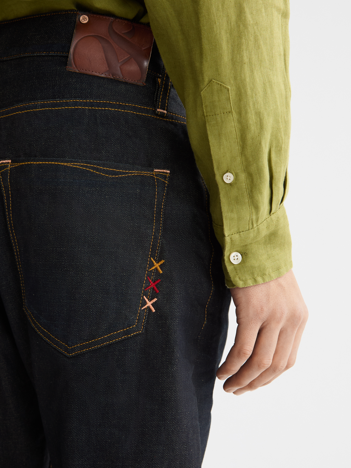 Scotch & Soda Dean tapered denim jeans showing slim fit, classic five-pocket design, and dark blue wash.
