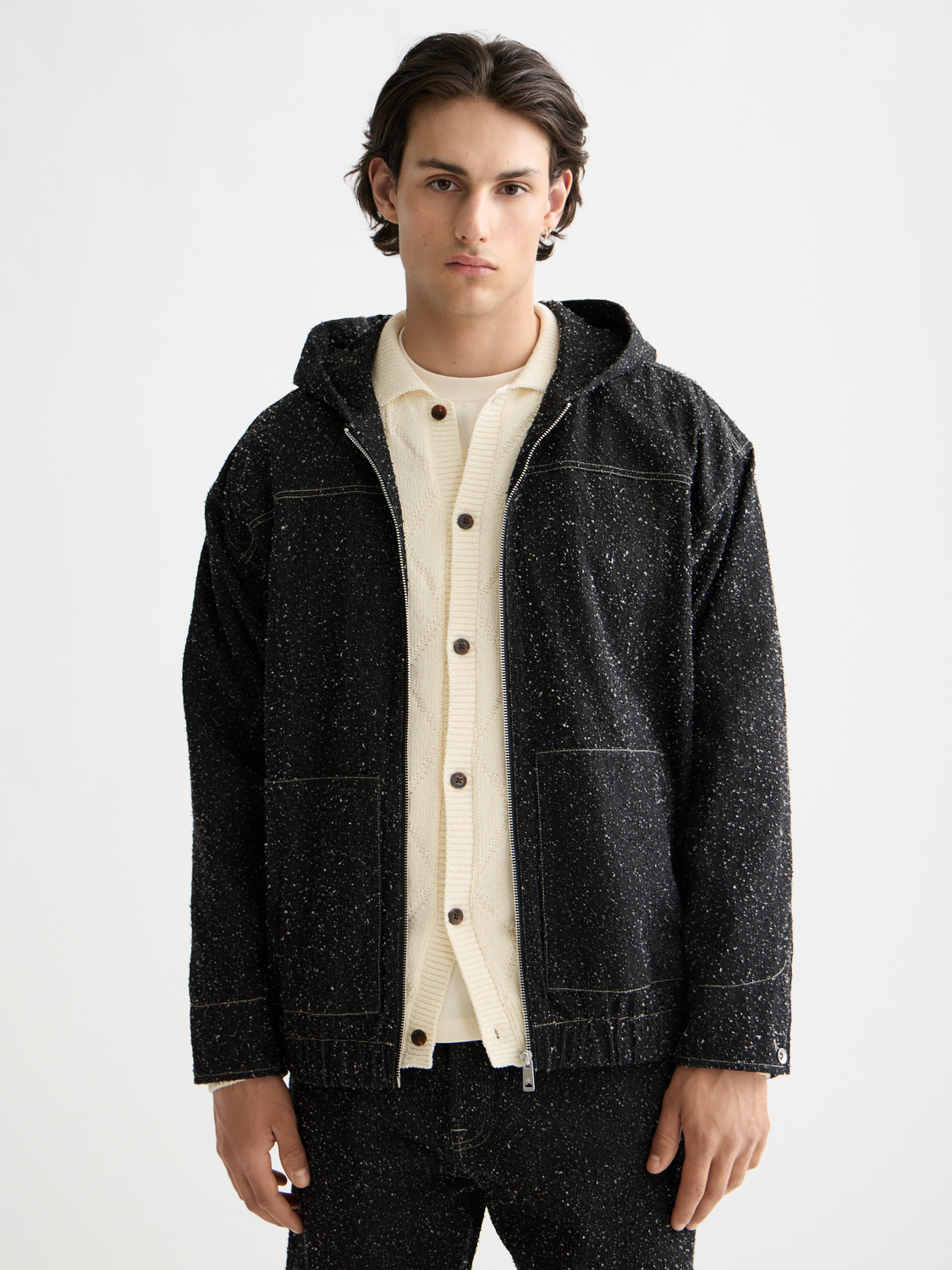 Blue denim jacket by Scotch & Soda with front pockets and button closure, styled on a hanger.