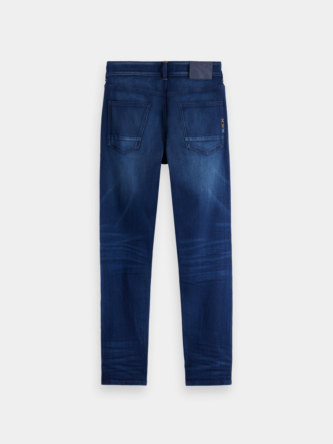 Slim-fit Ralston denim jeans by Scotch & Soda, shown in dark wash with classic five-pocket design and modern fit.