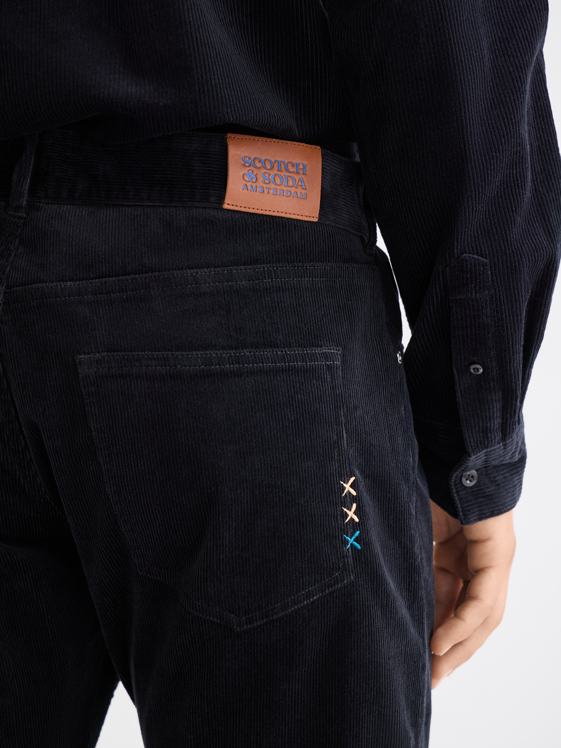 SCOTCH & SODA Zee straight-fit pants in neutral fabric, displayed on a hanger with a plain background.