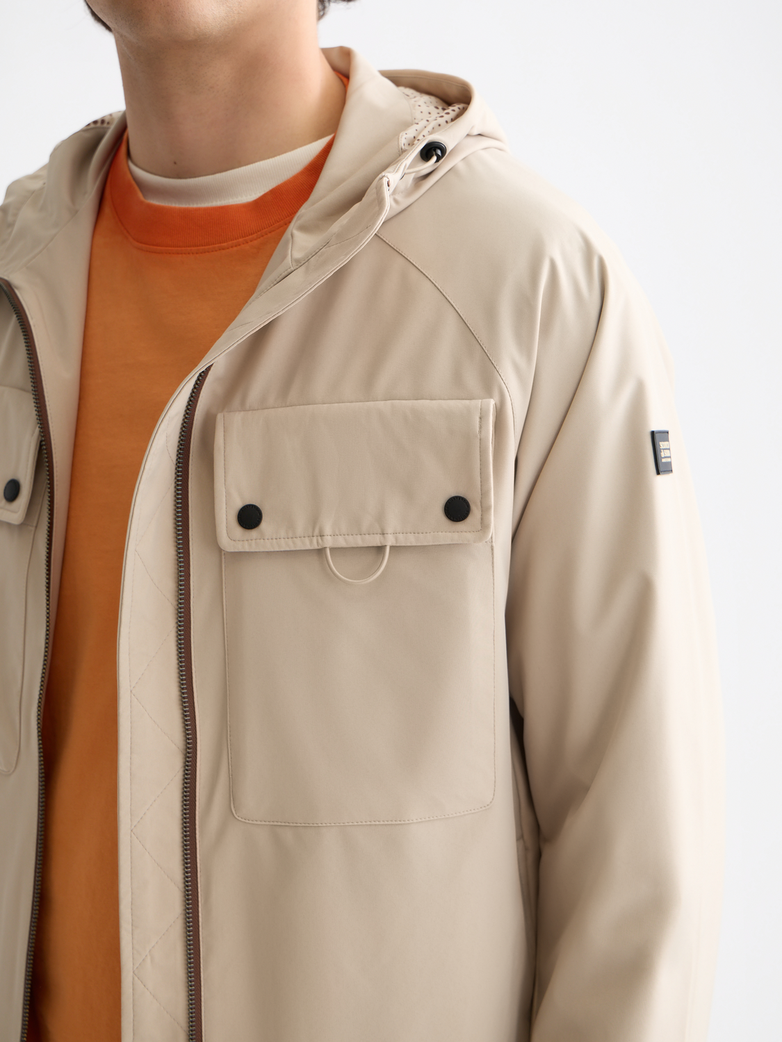 Scotch & Soda hooded softshell jacket featuring a sleek design, front zipper, and adjustable hood for outdoor protection.