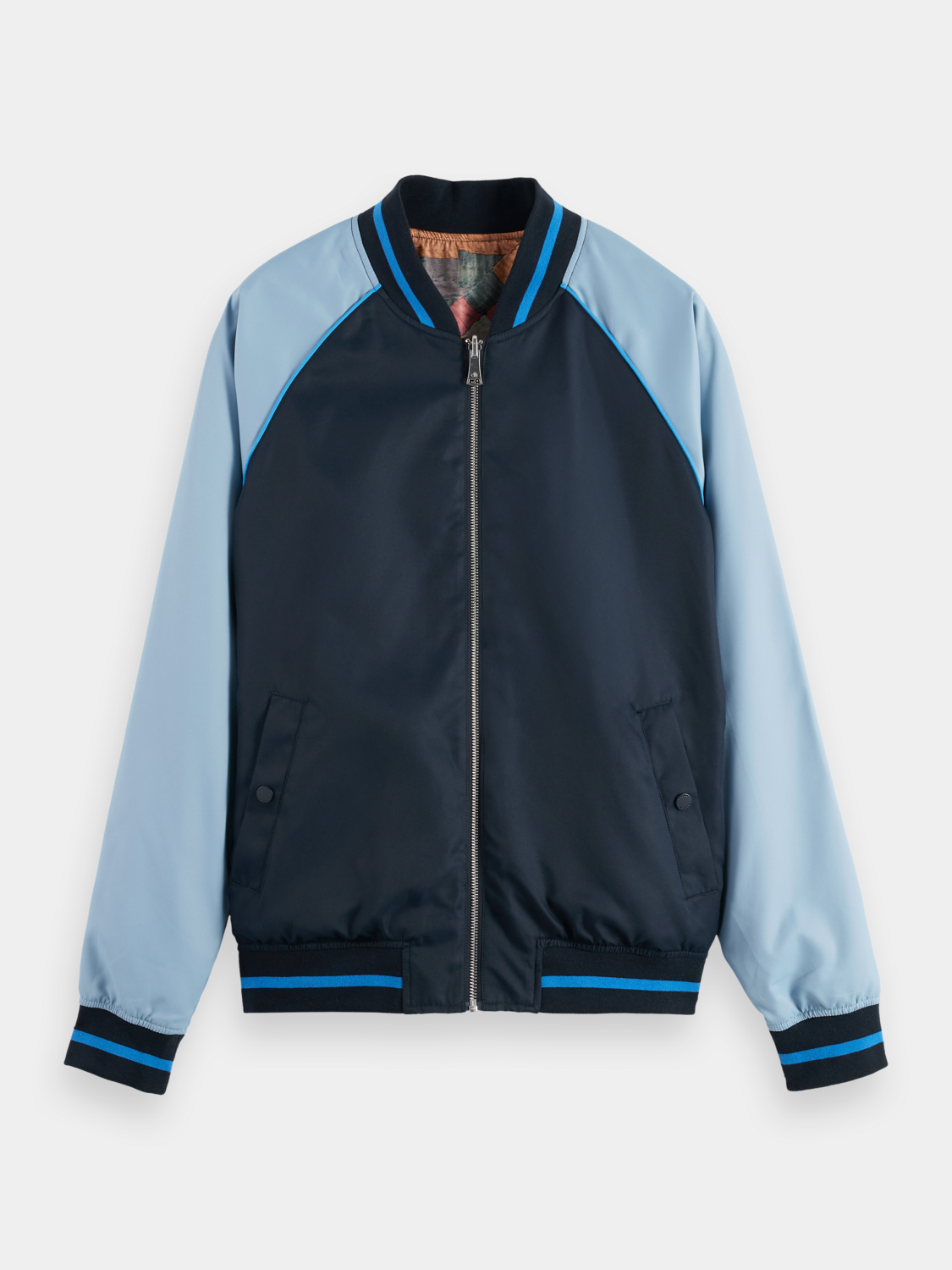Reversible bomber jacket by Scotch & Soda featuring stylish design and two-tone fabric, displayed on a hanger.