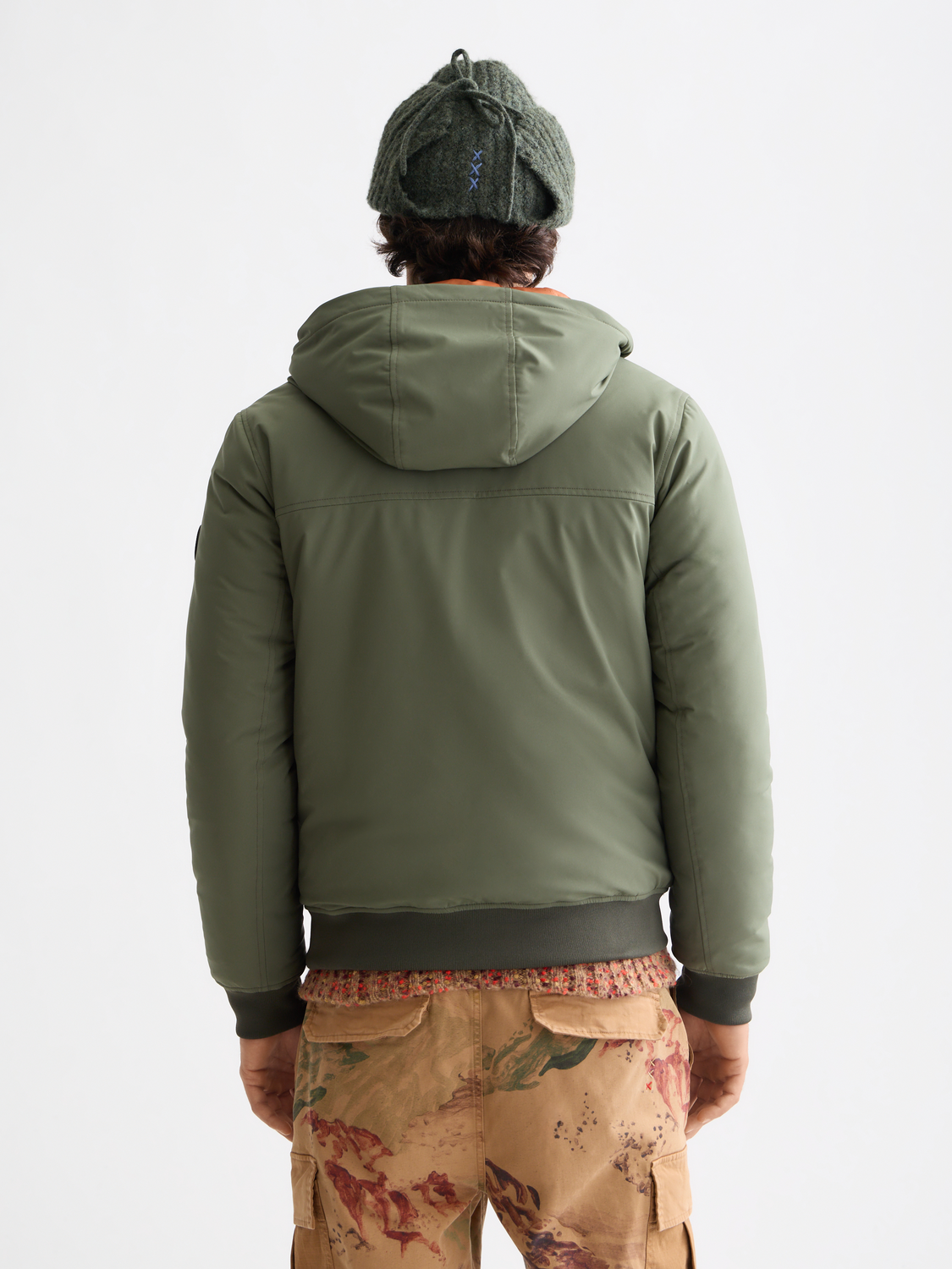 Scotch & Soda hooded softshell jacket showing a close-up of the black jacket with a front zipper and hood.