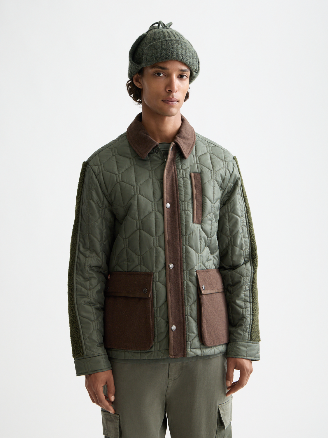 Scotch & Soda quilted military jacket with front button closure and multiple pockets, displayed on a hanger.